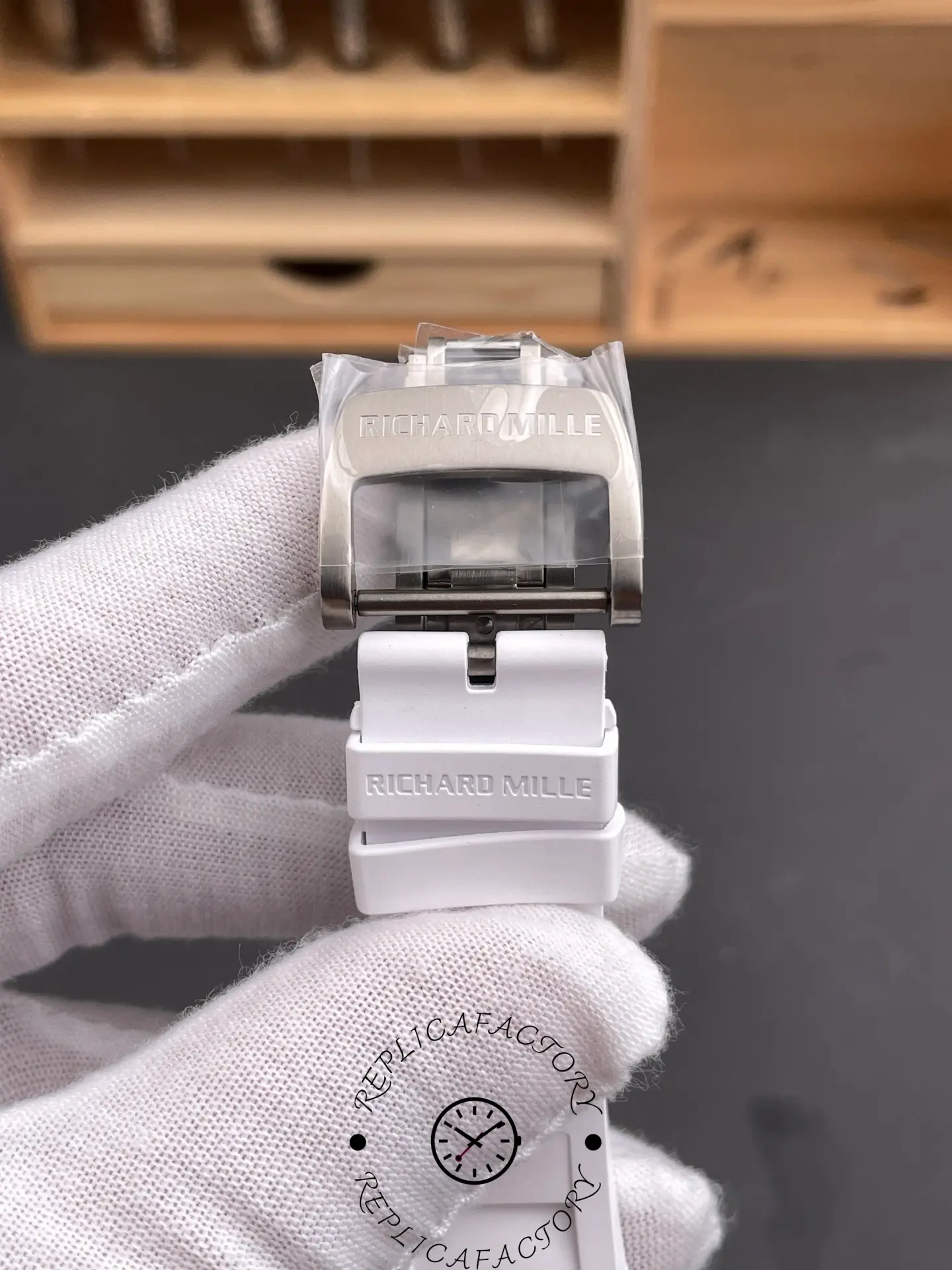 Clasp view of RM055 RMUL2 showing titanium buckle engraved with Richard Mille logo.