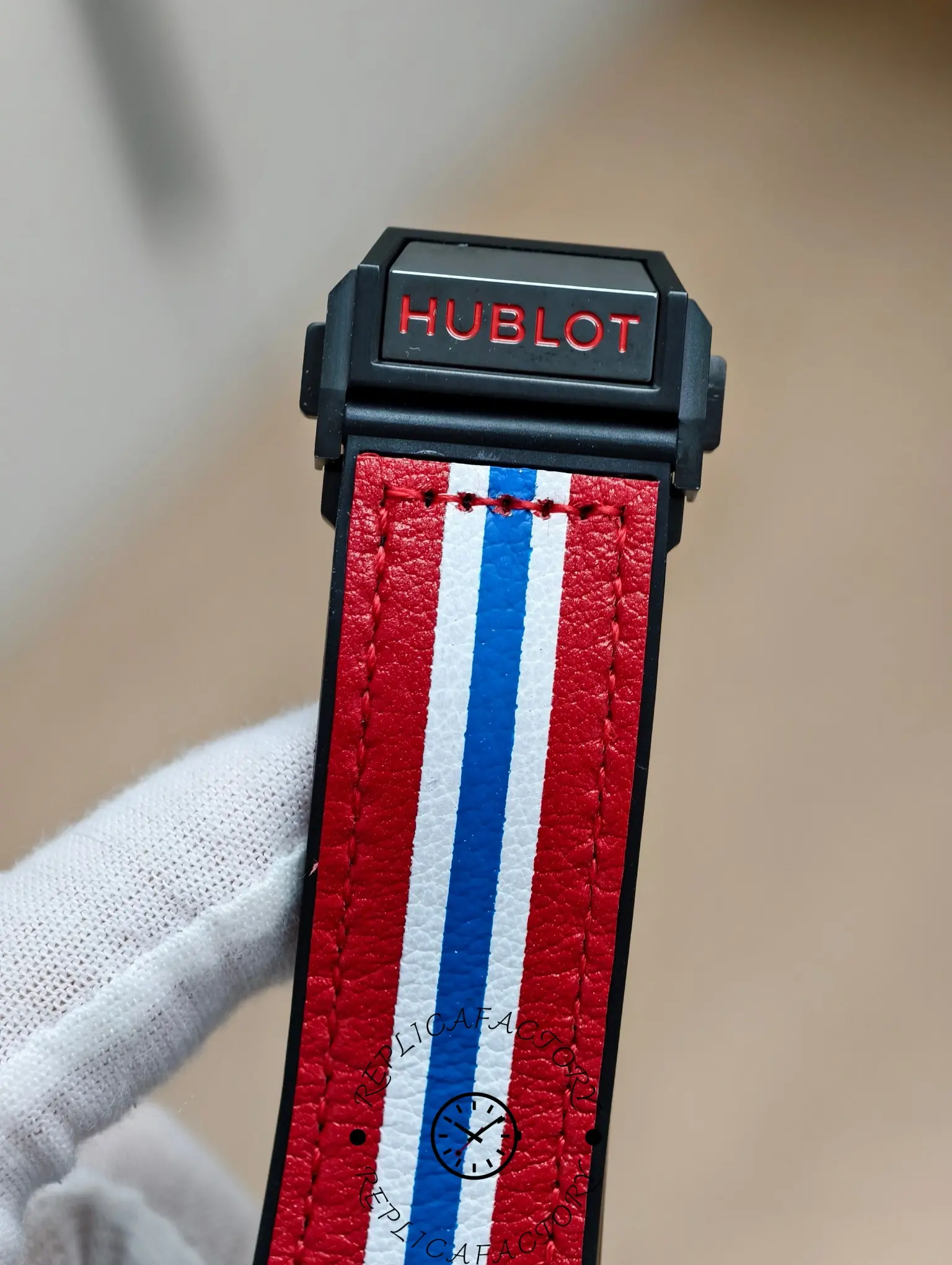 Clasp end of Hublot Big Bang 401.CX.1123.VR strap showing Hublot logo in red.