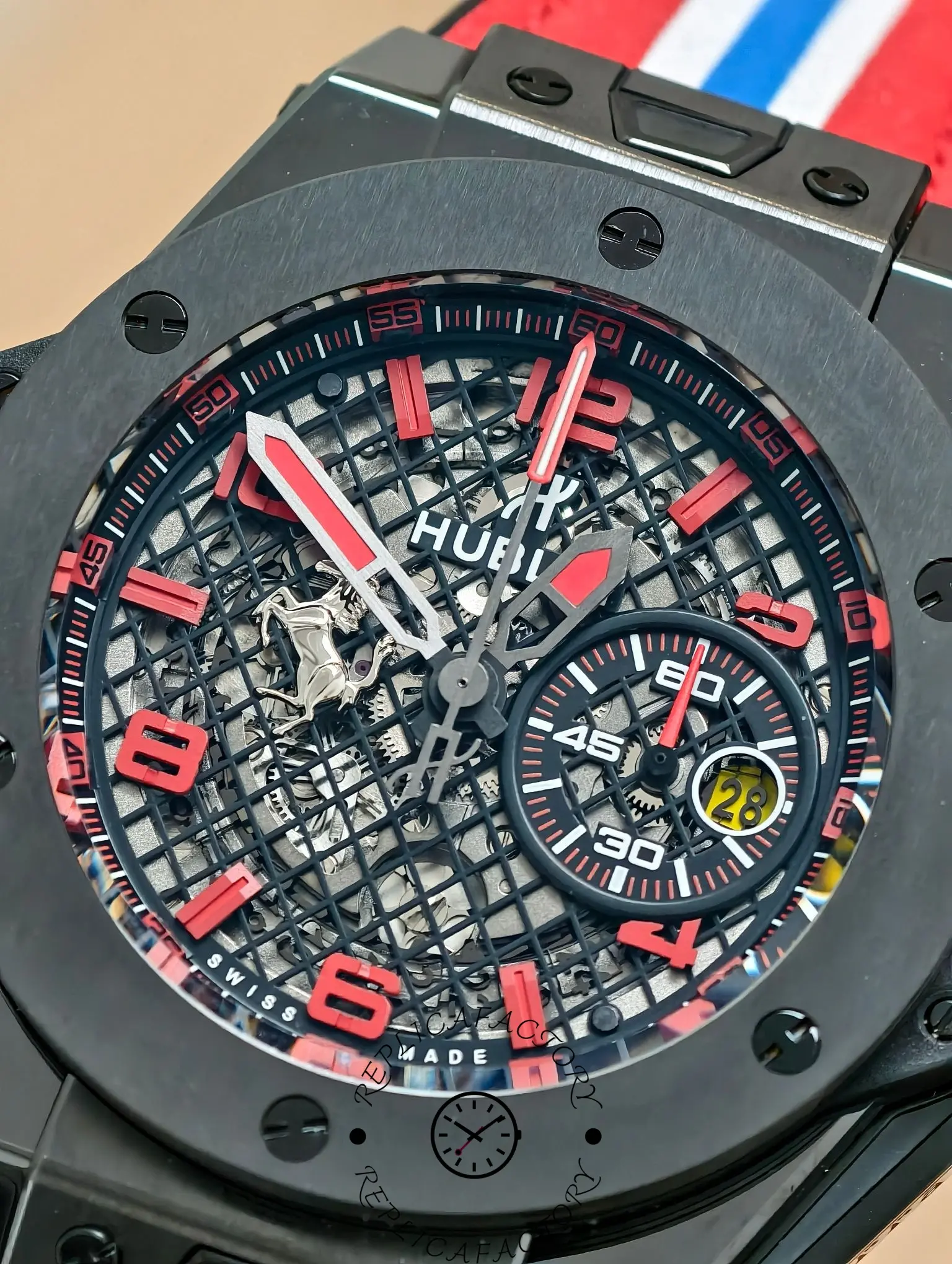 Macro view of Hublot Big Bang 401.CX.1123.VR dial with red numerals and grid skeleton design.