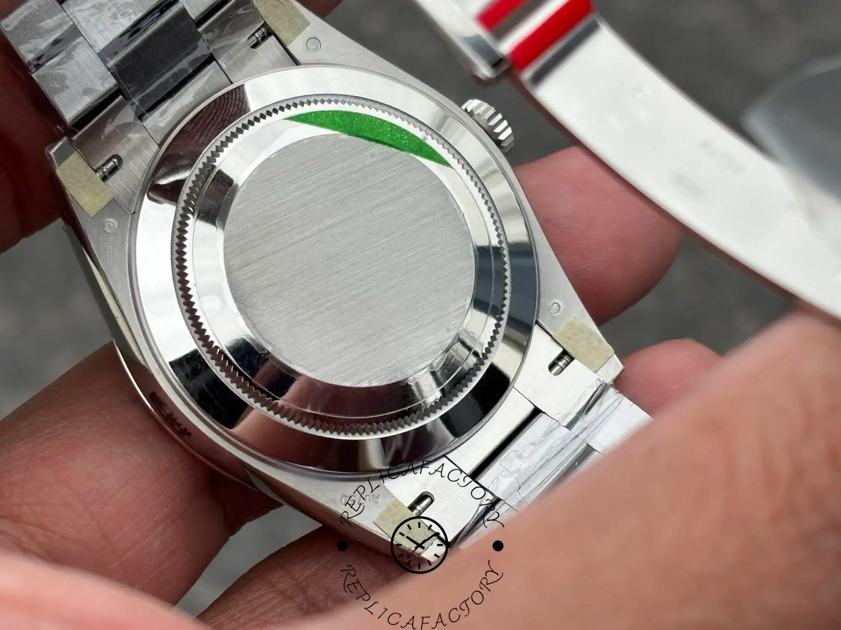 Back view of Rolex Day-Date 228239 showing solid screw-down caseback and bracelet links.