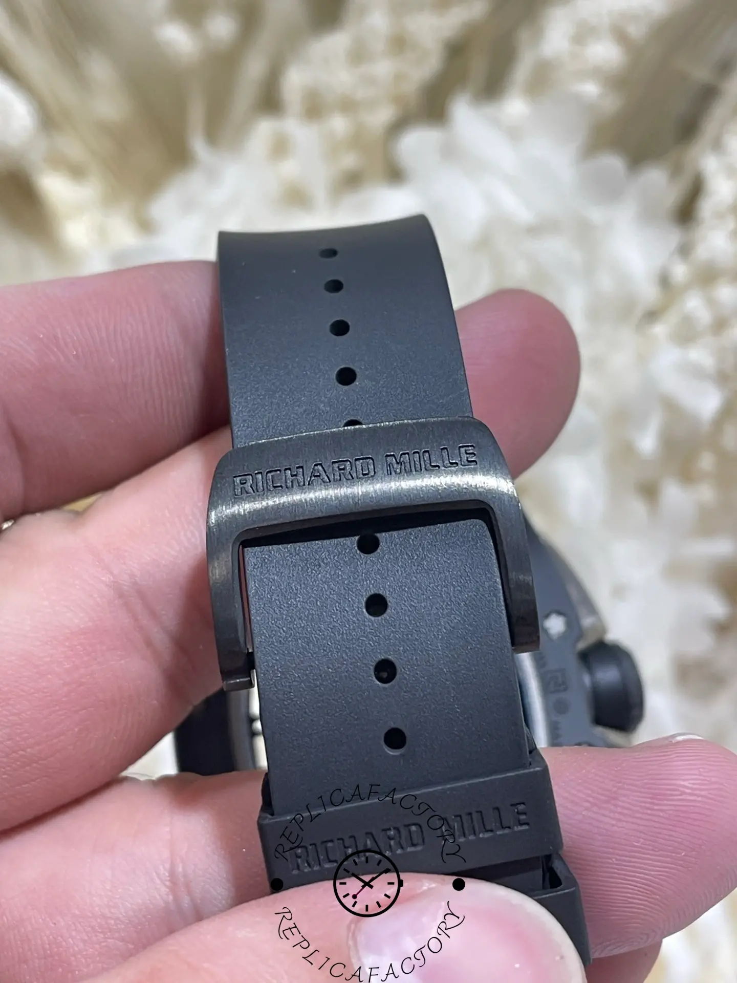 Strap and buckle of the RM61-01 replica with engraved Richard Mille logo.