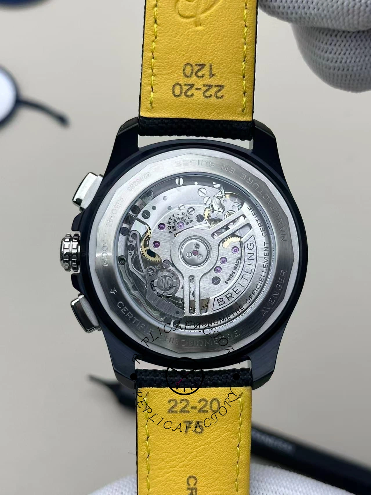 Rear movement view of Breitling Avenger B01 Chronograph 44 Night Mission SB0147101I1X2 with yellow leather backing.