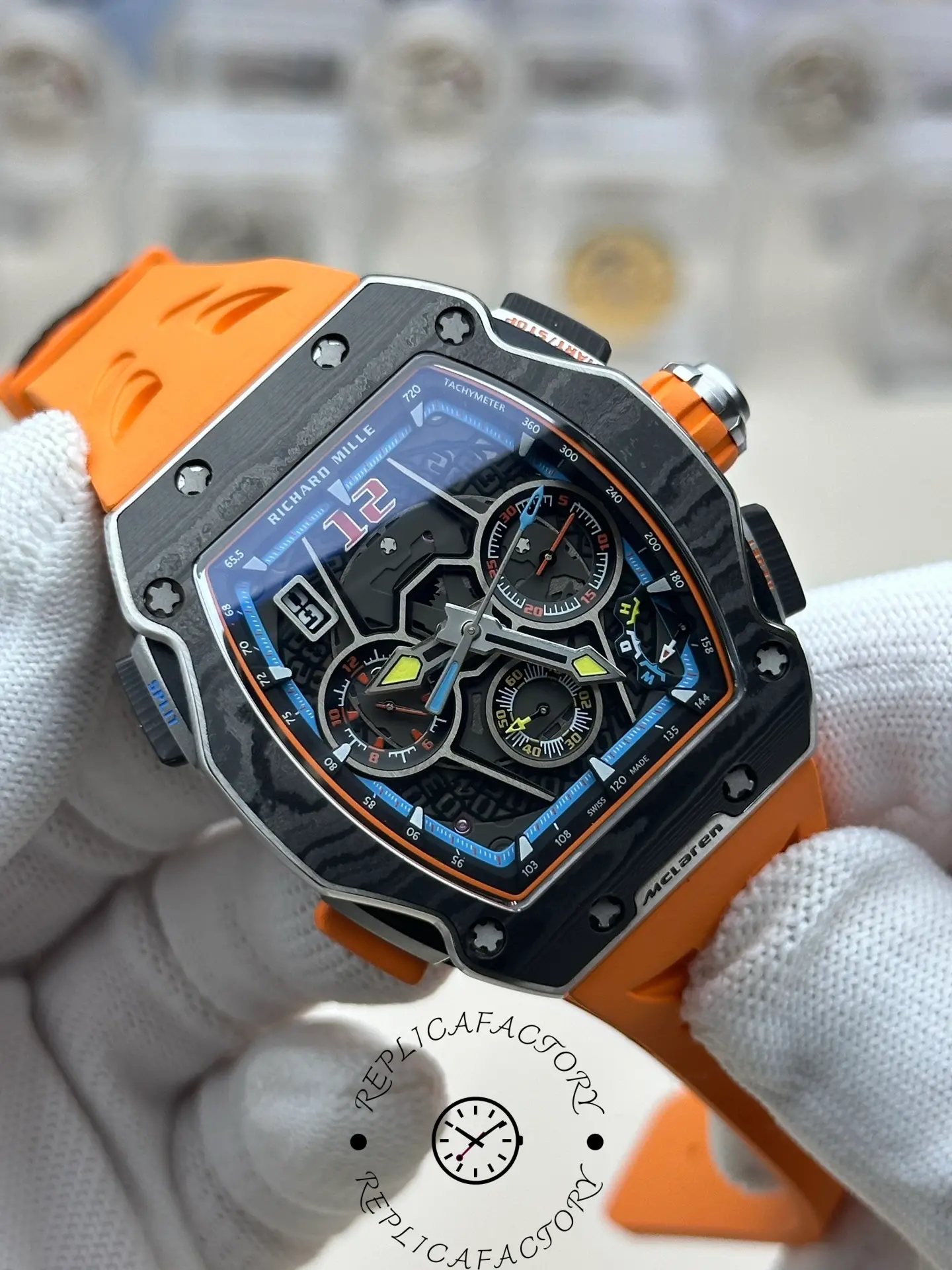 Angled view of RM 65-01 replica showing carbon case and orange rubber strap.