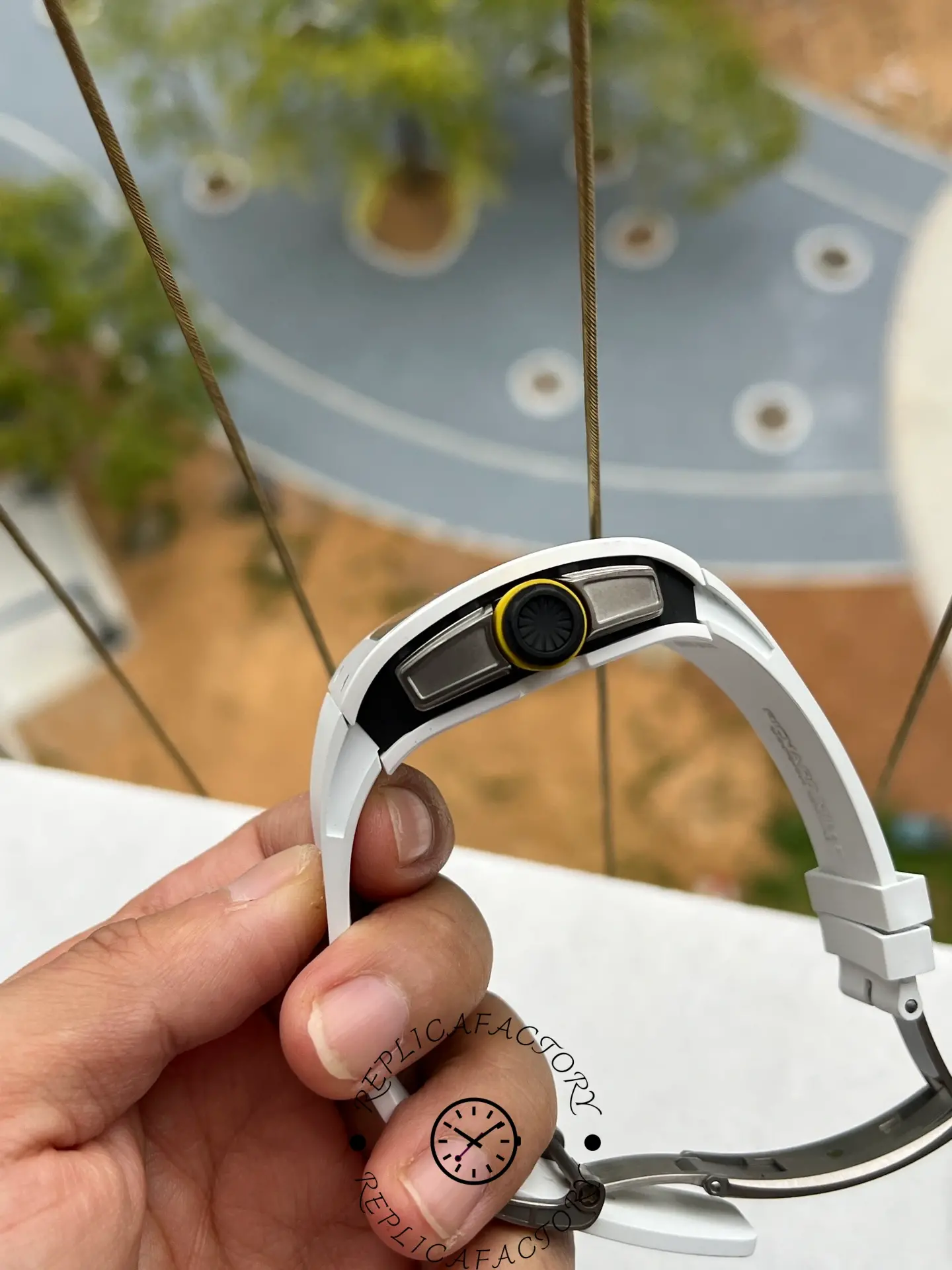 Close view of RM61-01 replica crown with yellow ring and case side design.