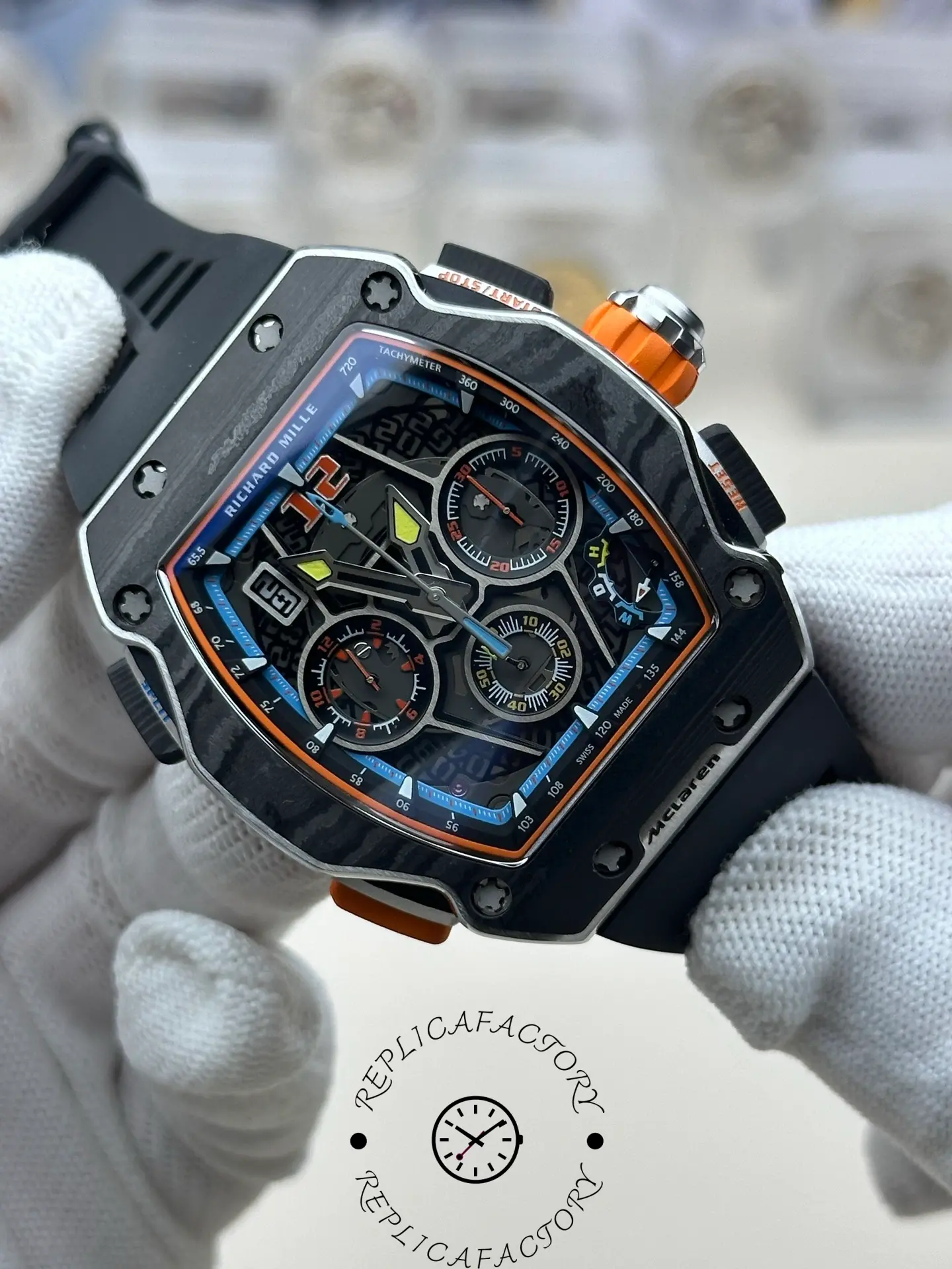 Angled view of RM 65-01 replica highlighting carbon TPT case and orange crown.