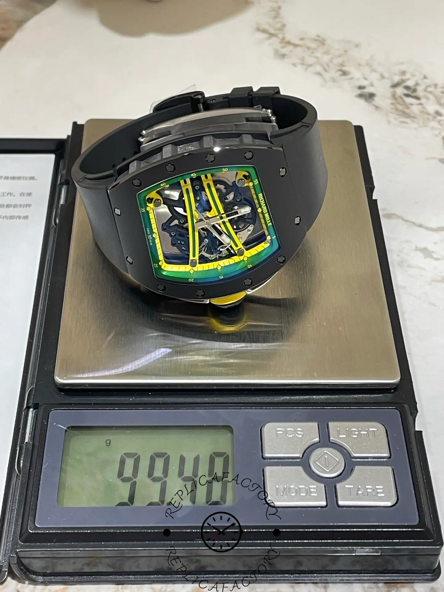 RM 061-01 replica placed on scale showing weight of 99.40 grams.