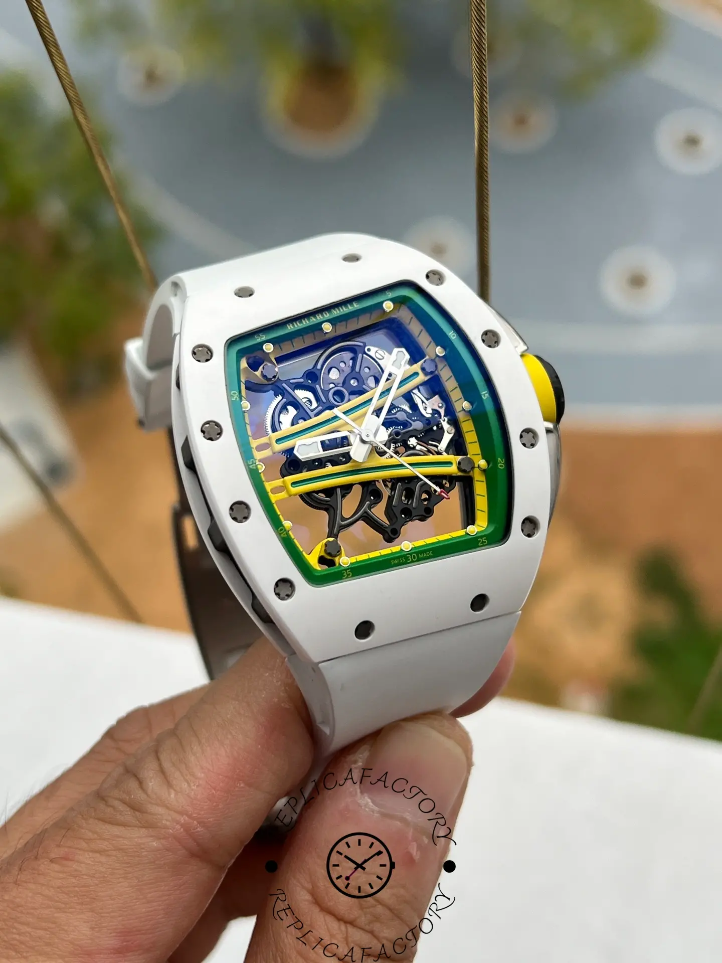 Side-angled shot of RM61-01 replica showing case curvature and vibrant dial details.