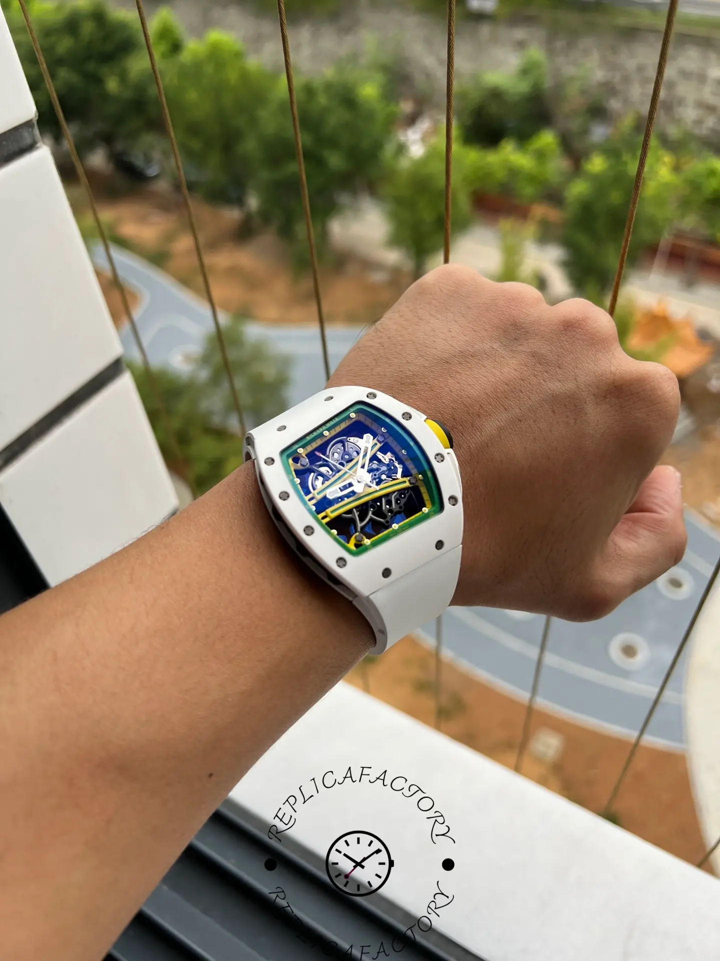 Wrist shot of RM61-01 replica displaying full dial visibility outdoors.