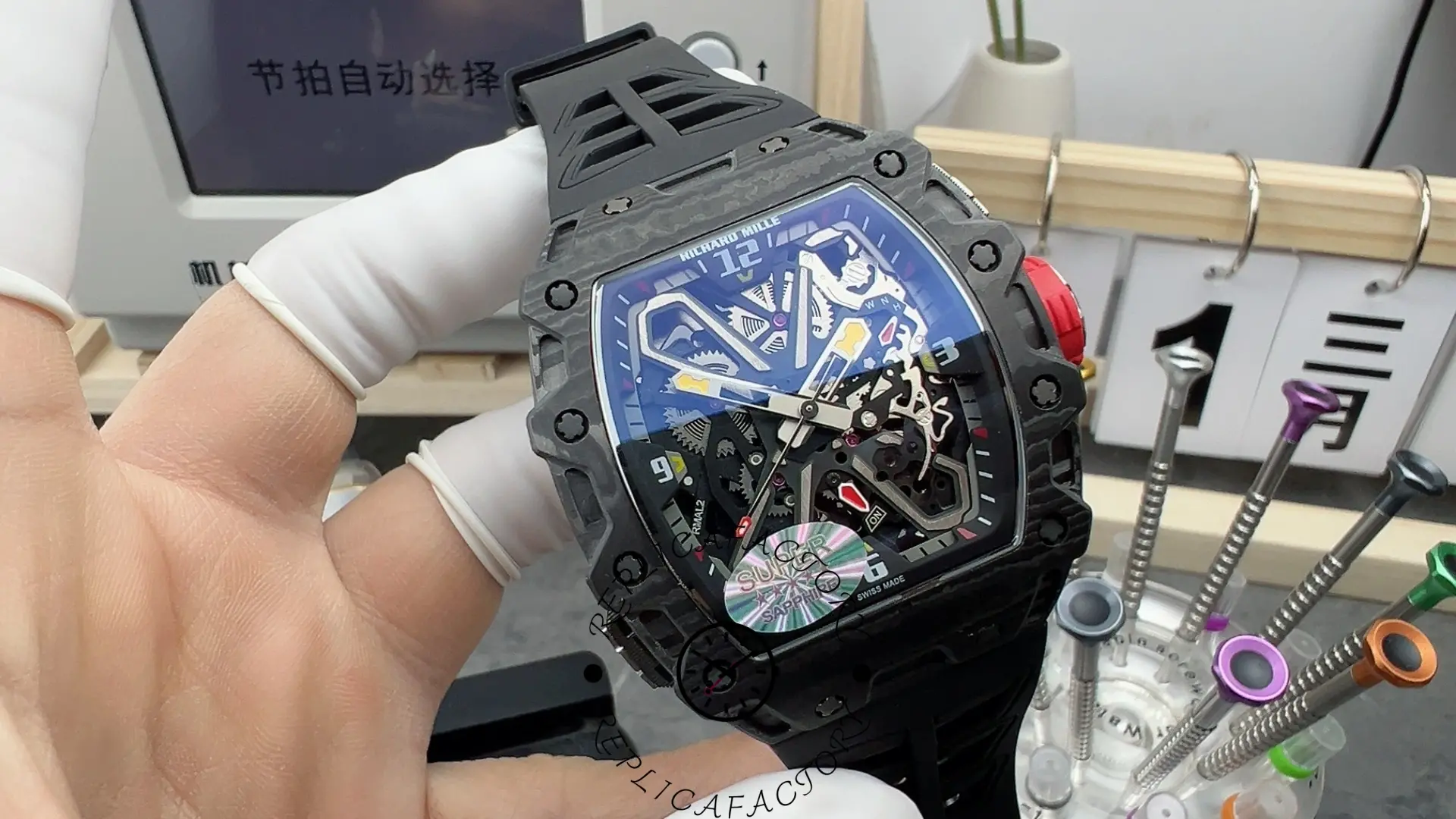 Handheld view of RM35-03 showing carbon case, red crown and skeleton movement.
