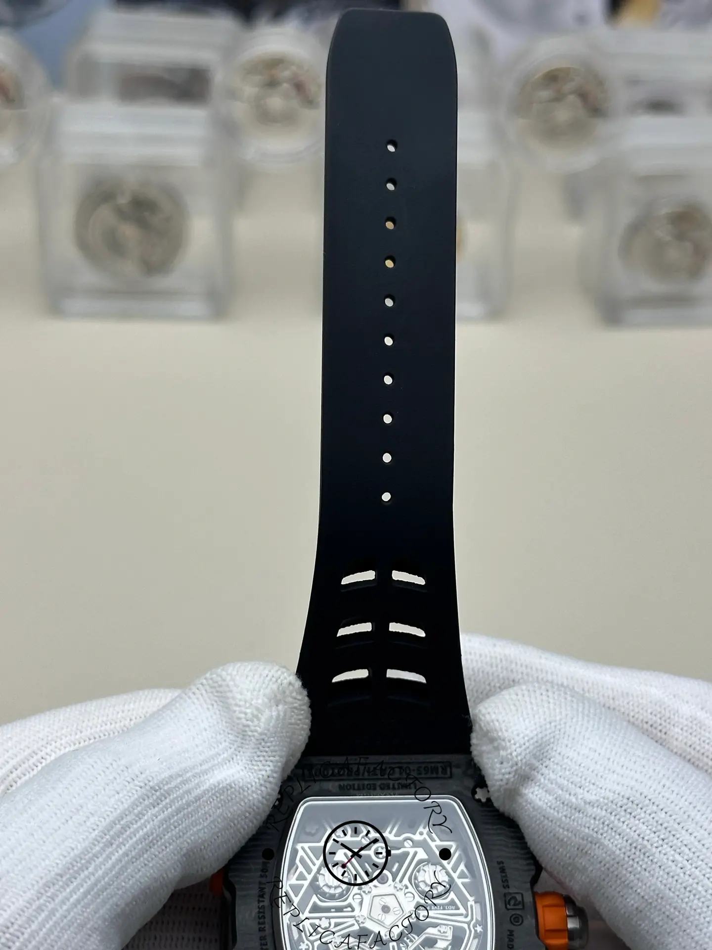 Rubber strap section of the RM 65-01 replica with adjustment holes visible.