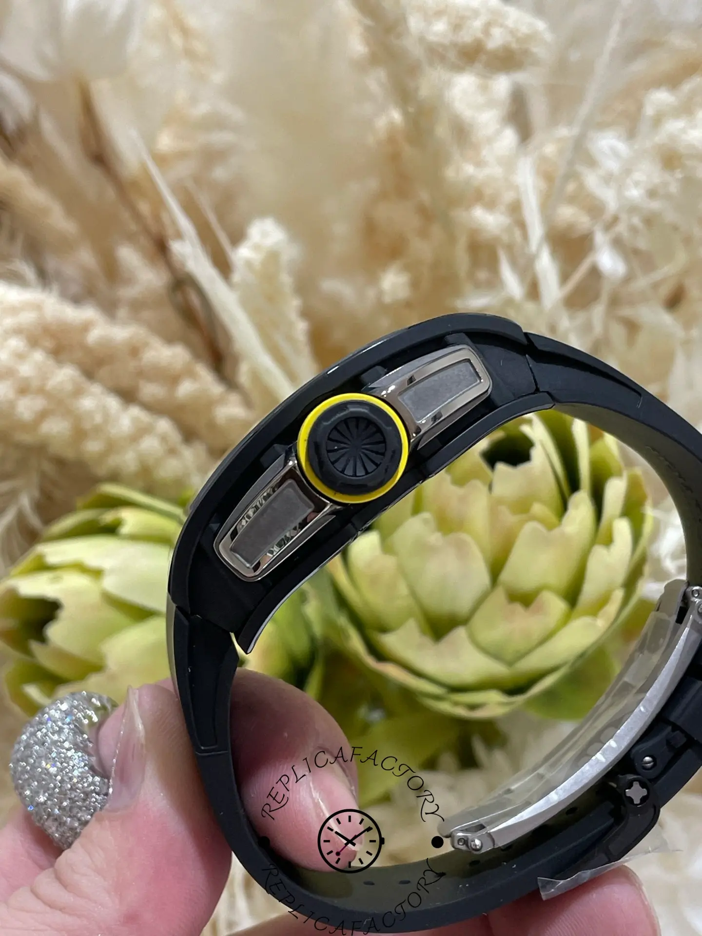 Side crown detail of RM 061-01 replica featuring yellow rubber ring and textured design.