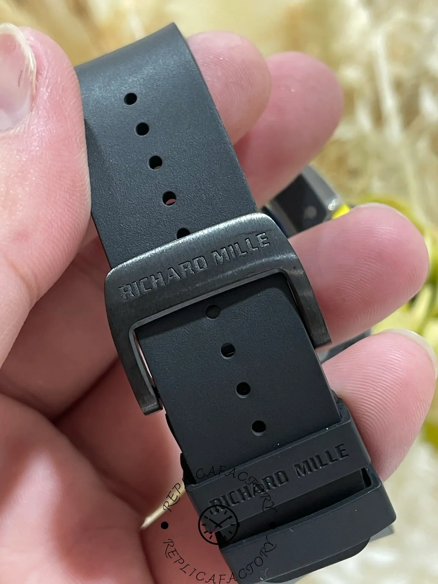 Clasp close-up of RM 061-01 replica rubber strap with engraved buckle.