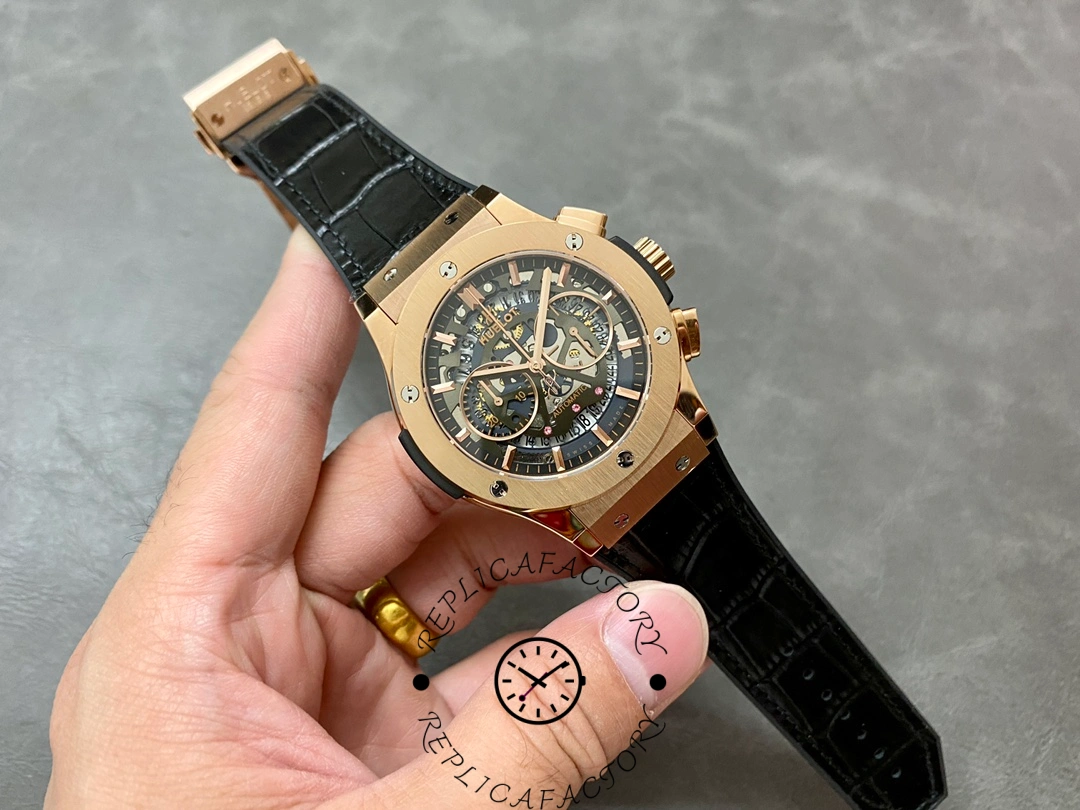 Full watch view of Hublot 525.OX.0180.LR replica held in hand.