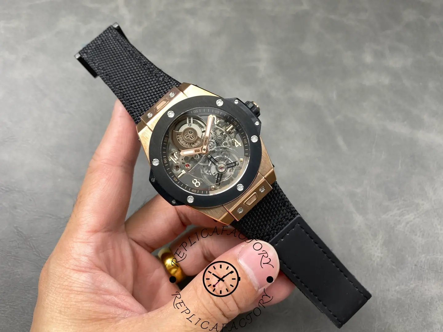 Full watch view of 414.OI.1123.RX King Gold Ceramic with black fabric strap.