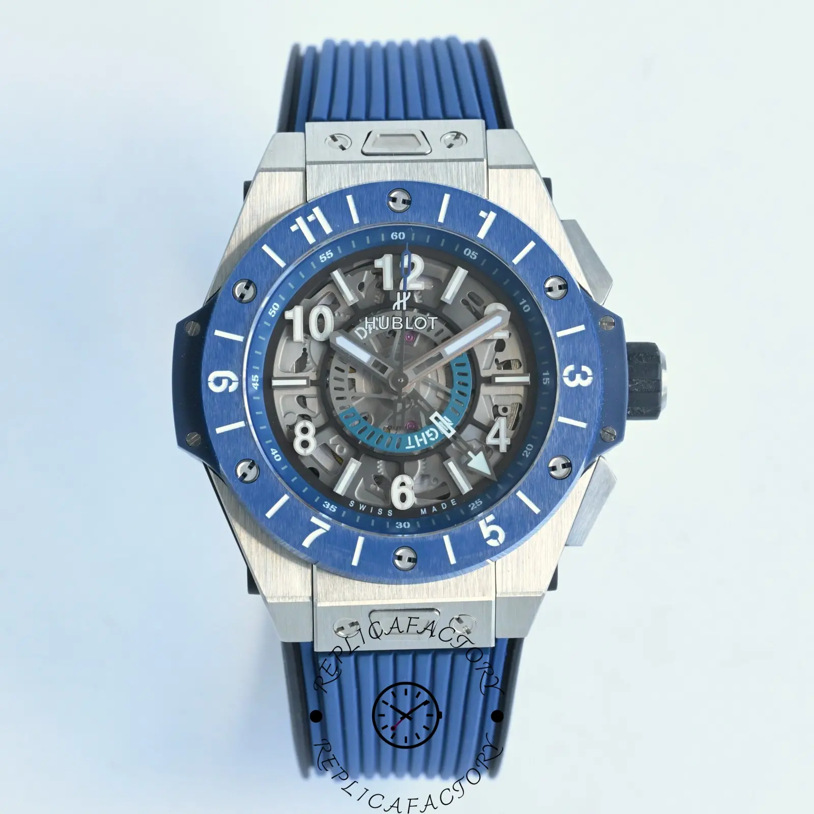Direct front shot of Hublot 471.NL.7112.RX with blue rubber strap and open-worked dial.