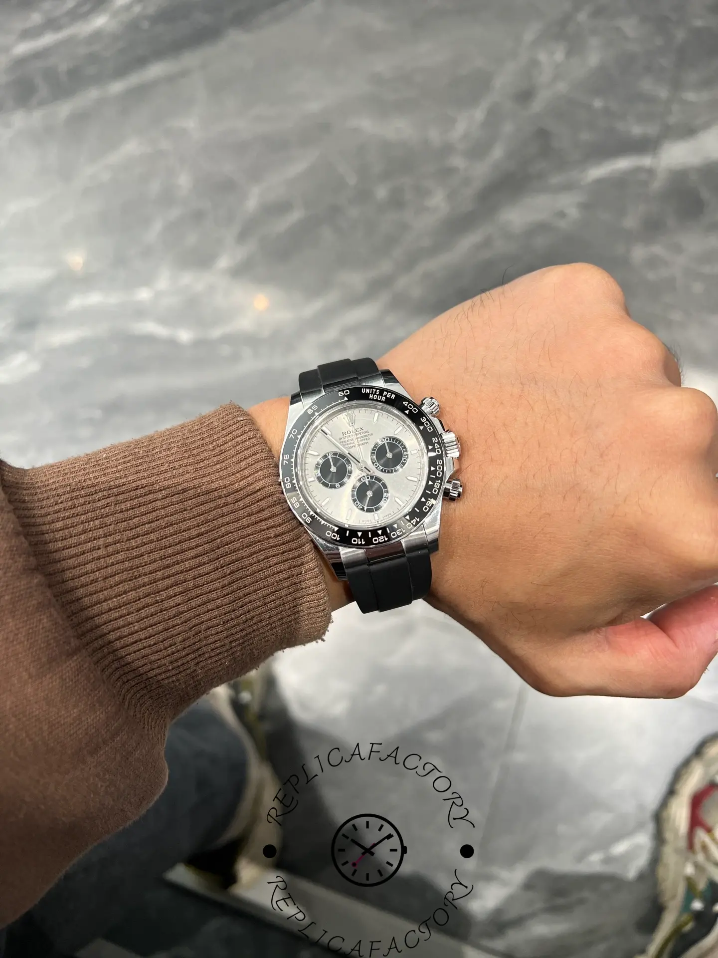 Wrist shot of Rolex Daytona 126519LN showing silver dial and black subdials on Oysterflex strap.