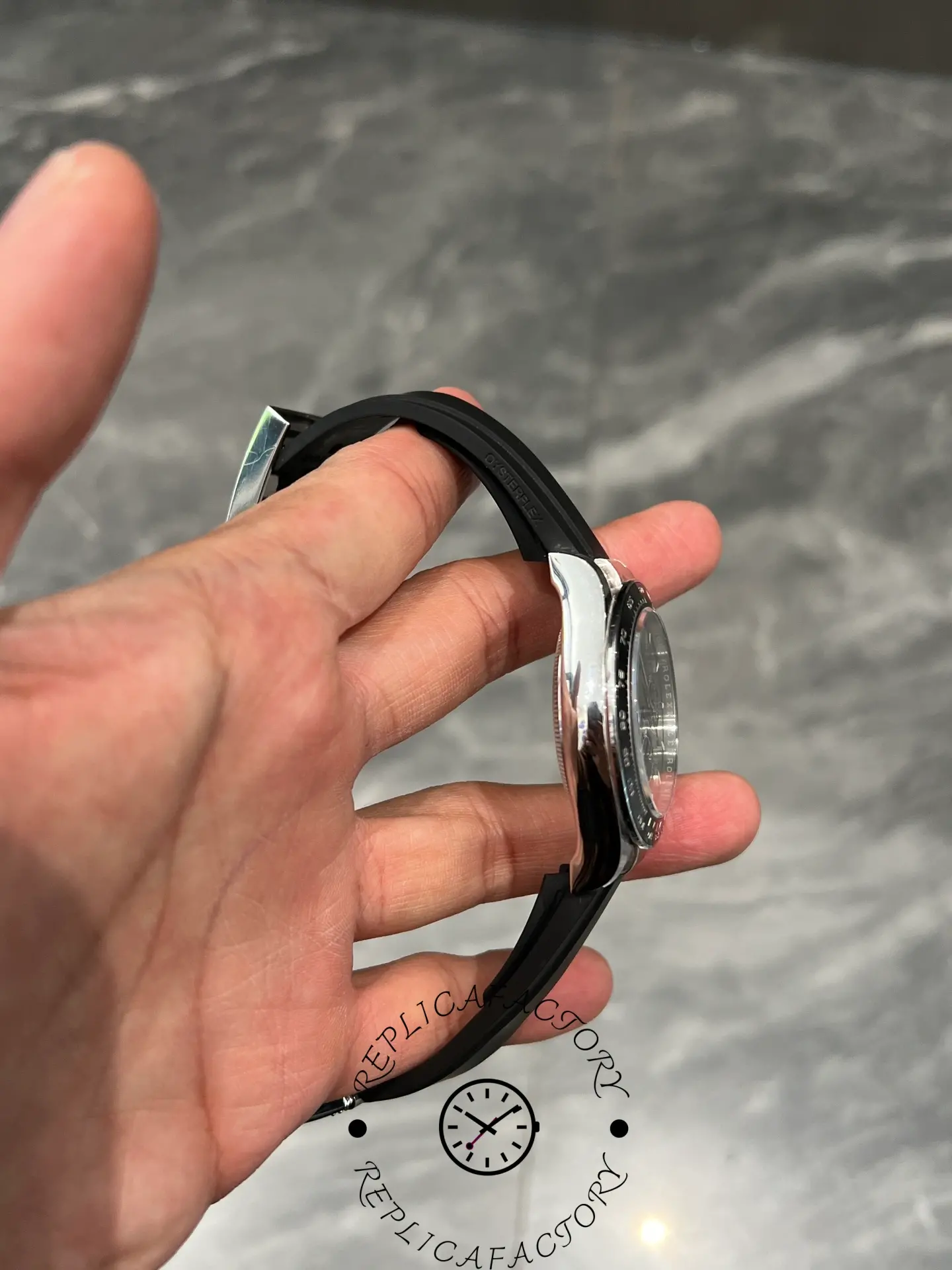 Side profile of Rolex Daytona 126519LN with curved Oysterflex strap and polished white gold case.