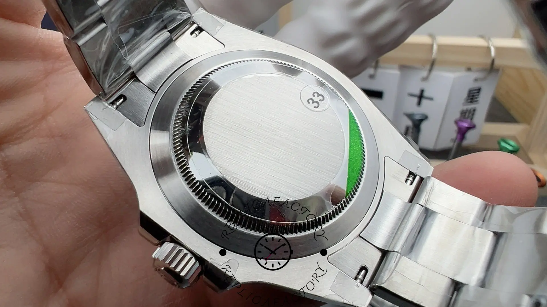 Caseback of the Rolex Submariner 126610LV with protective stickers applied.