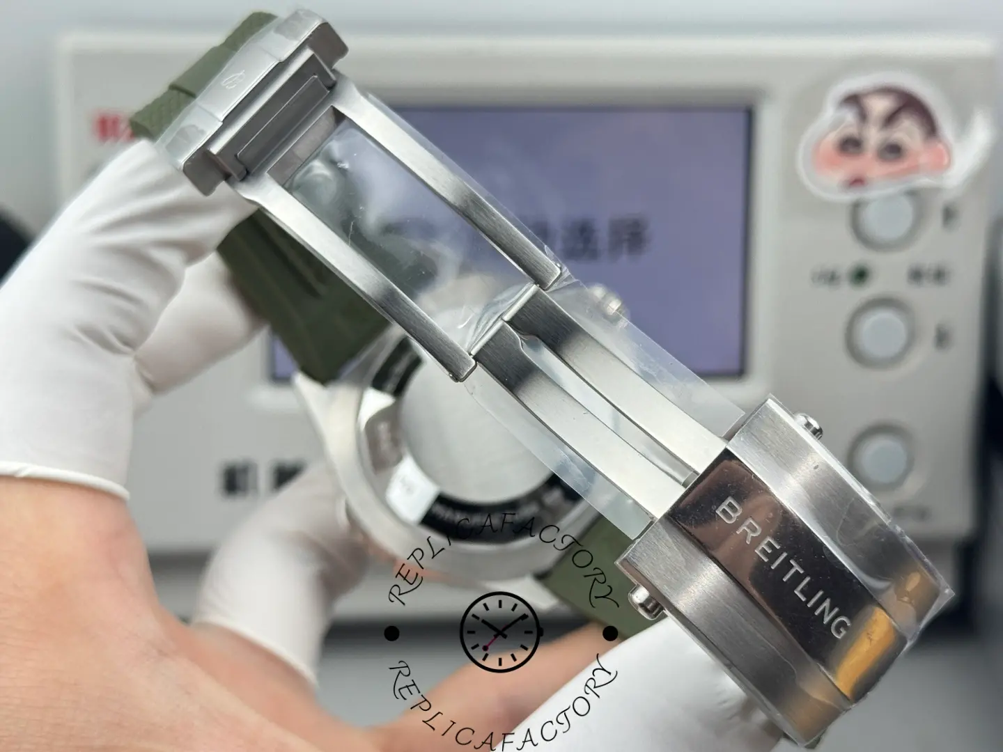 Breitling Superocean E10379D31L1S1 clasp view showing stainless steel deployant buckle and green rubber strap.