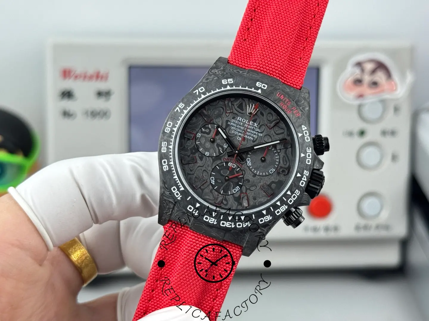 Close-up of Rolex Daytona DIW NTPT Carbon Red Edition showing tachymeter bezel.