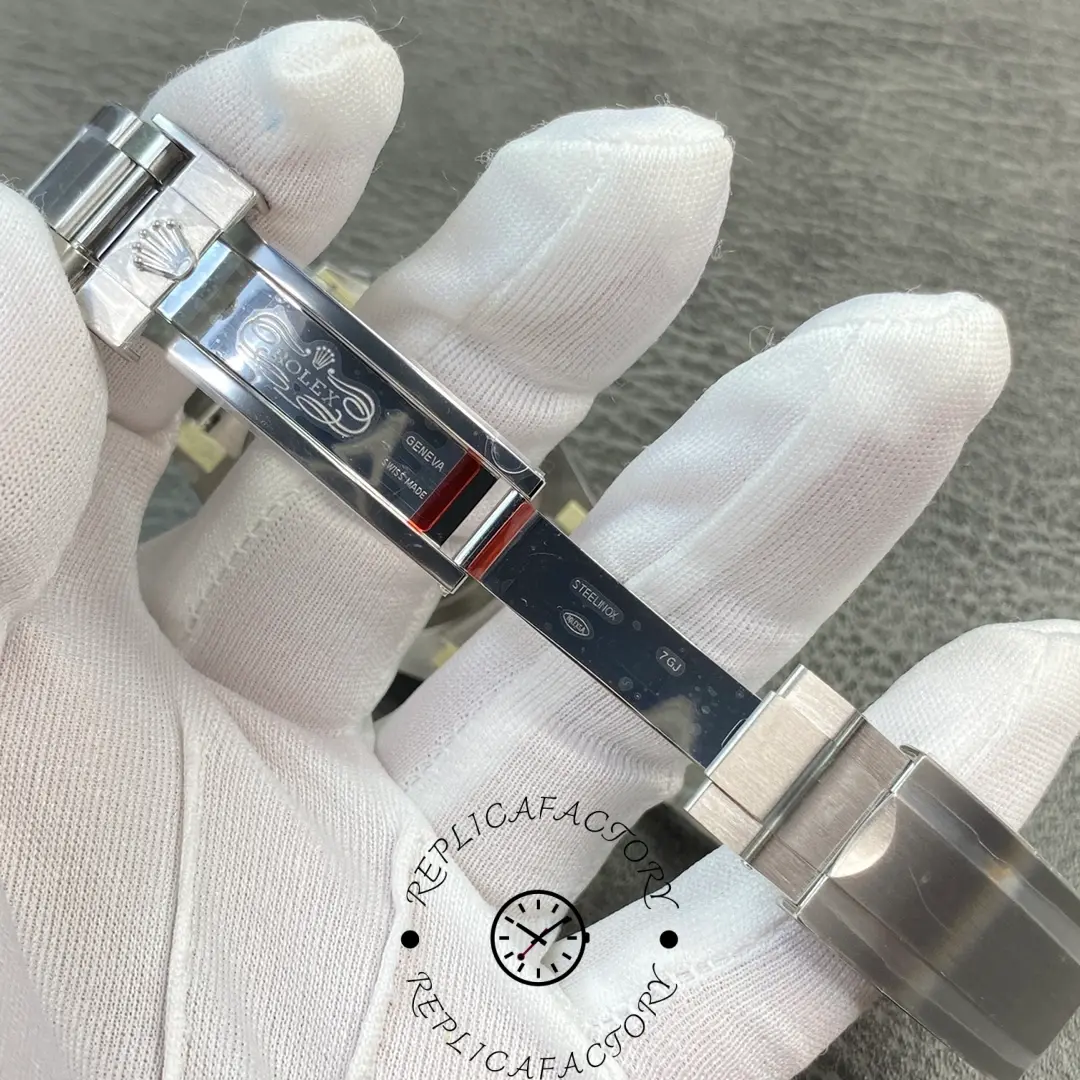 Inside view of Rolex Submariner 114060 clasp showing Rolex engravings and steel markings.