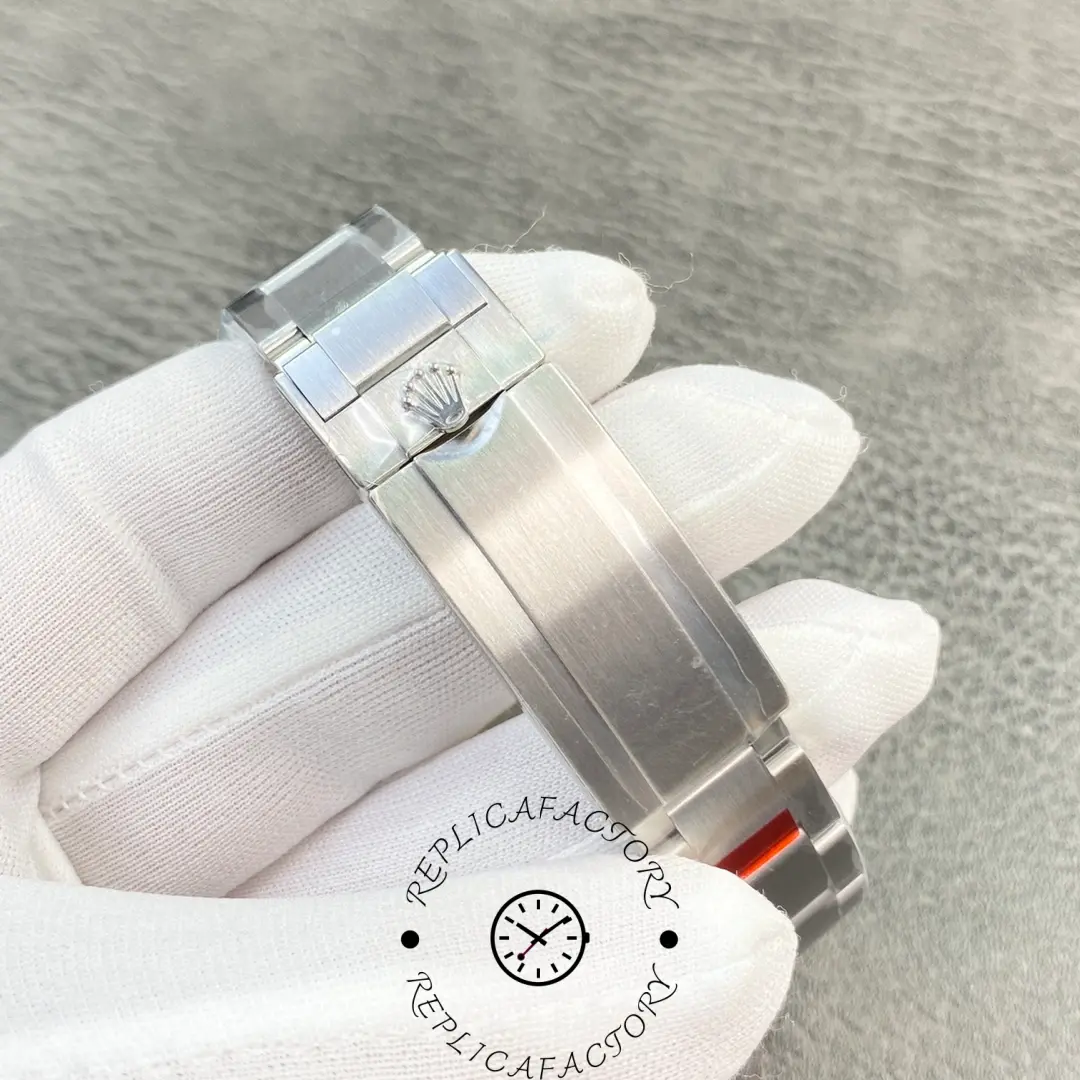 Close-up of Rolex Submariner 114060 clasp showing engraved Rolex crown.