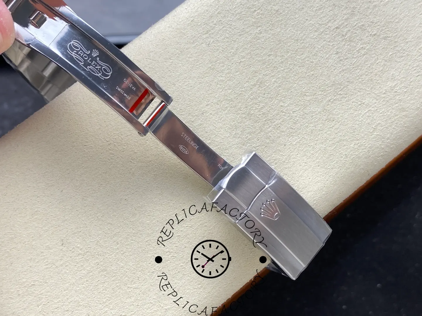 Close-up of replica Rolex 277200 clasp interior showing engraved markings and polished steel finish.