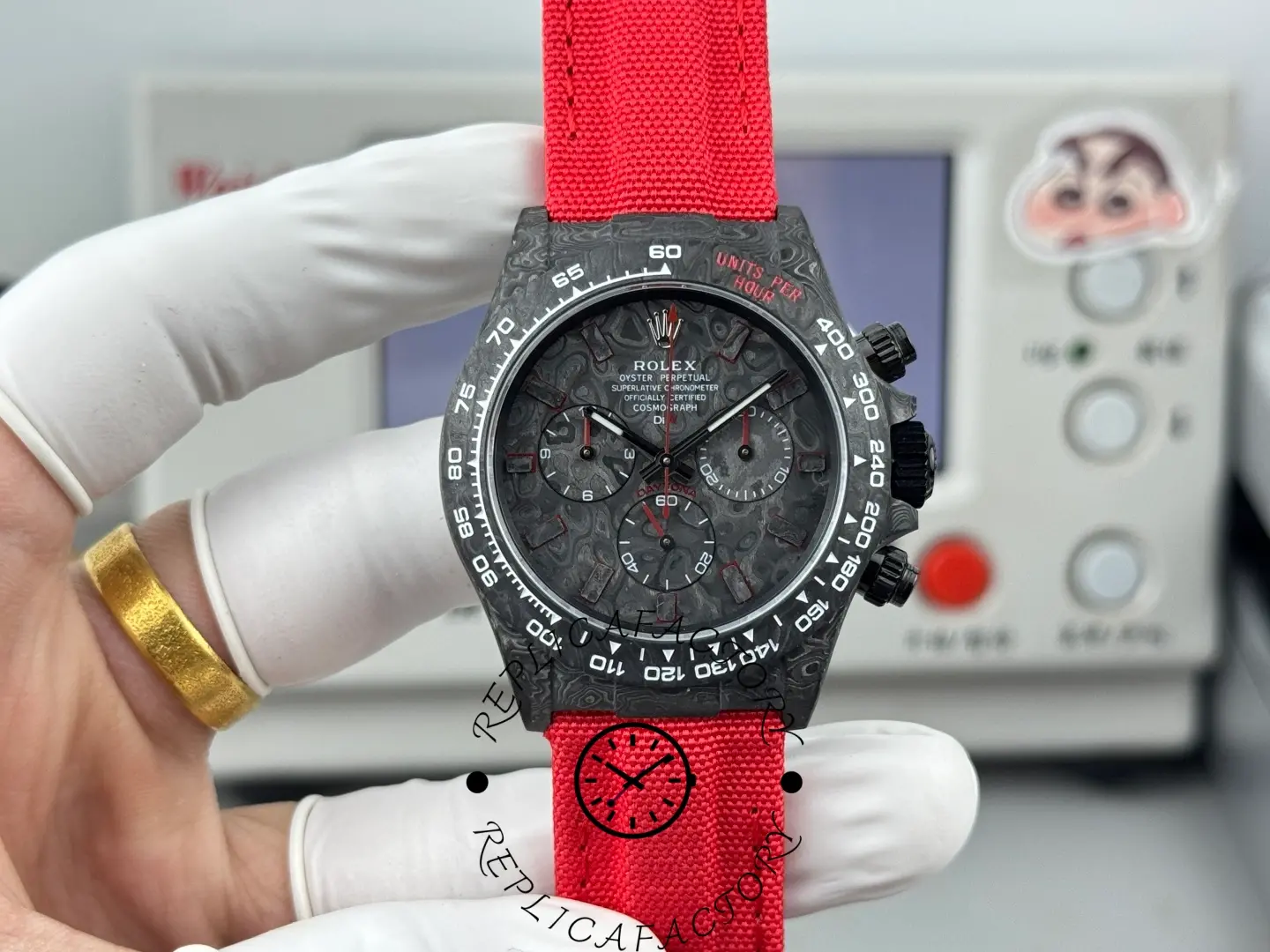 Hand-held view of Rolex Daytona DIW NTPT Carbon Red Edition showing carbon bezel and dial.