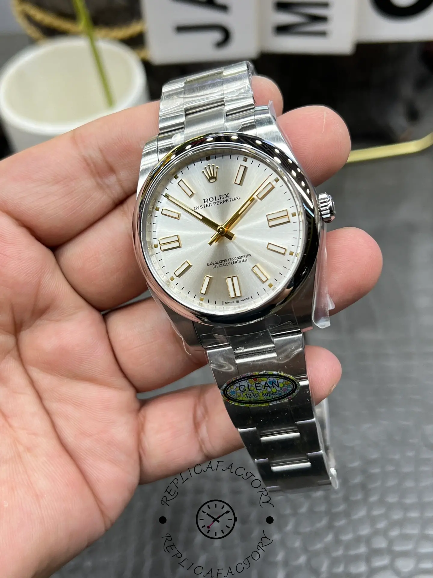 Wrist-level angle of the Rolex replica M124300-0001 with silver dial and baton markers.