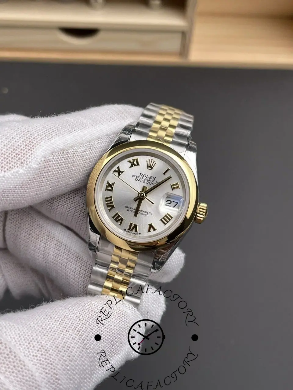 Front angled shot of Rolex 279163-0005 replica showing gold bezel and two-tone bracelet.