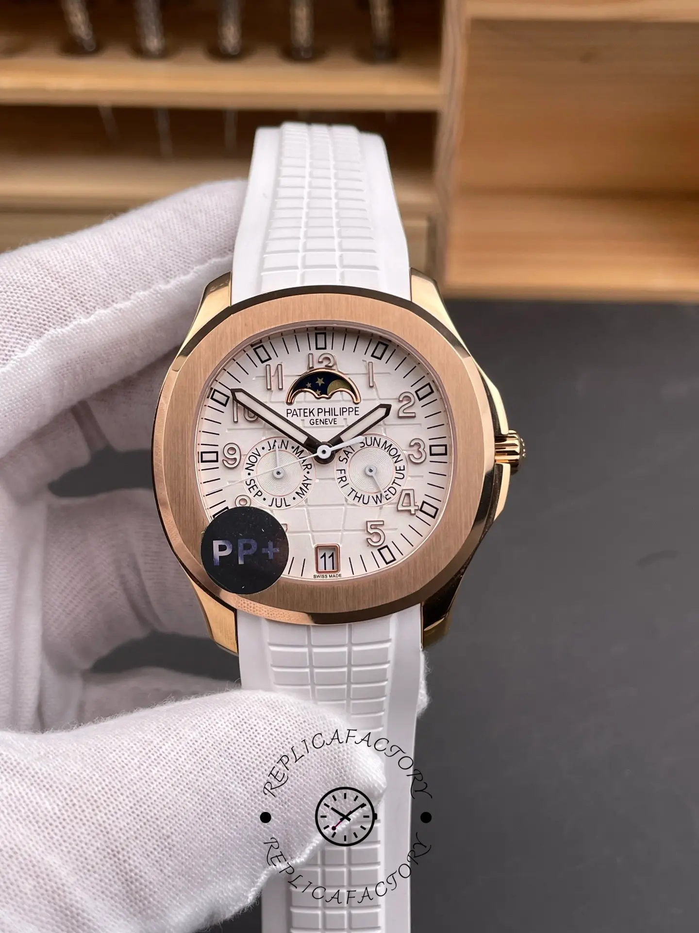 Handheld close-up of 5261R dial with annual calendar subdials and white strap.