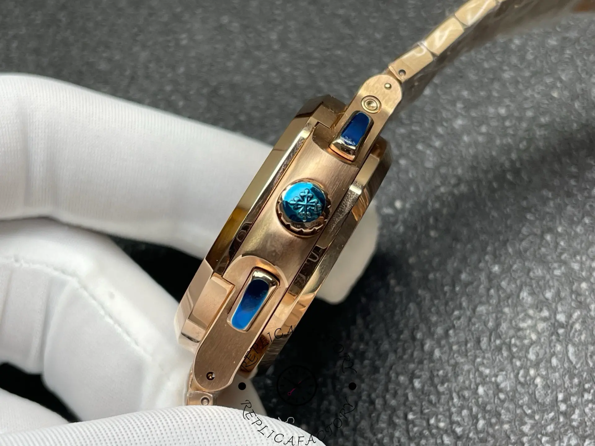 Side crown and pushers of Patek Philippe 5990/1R-001 replica with blue accents.