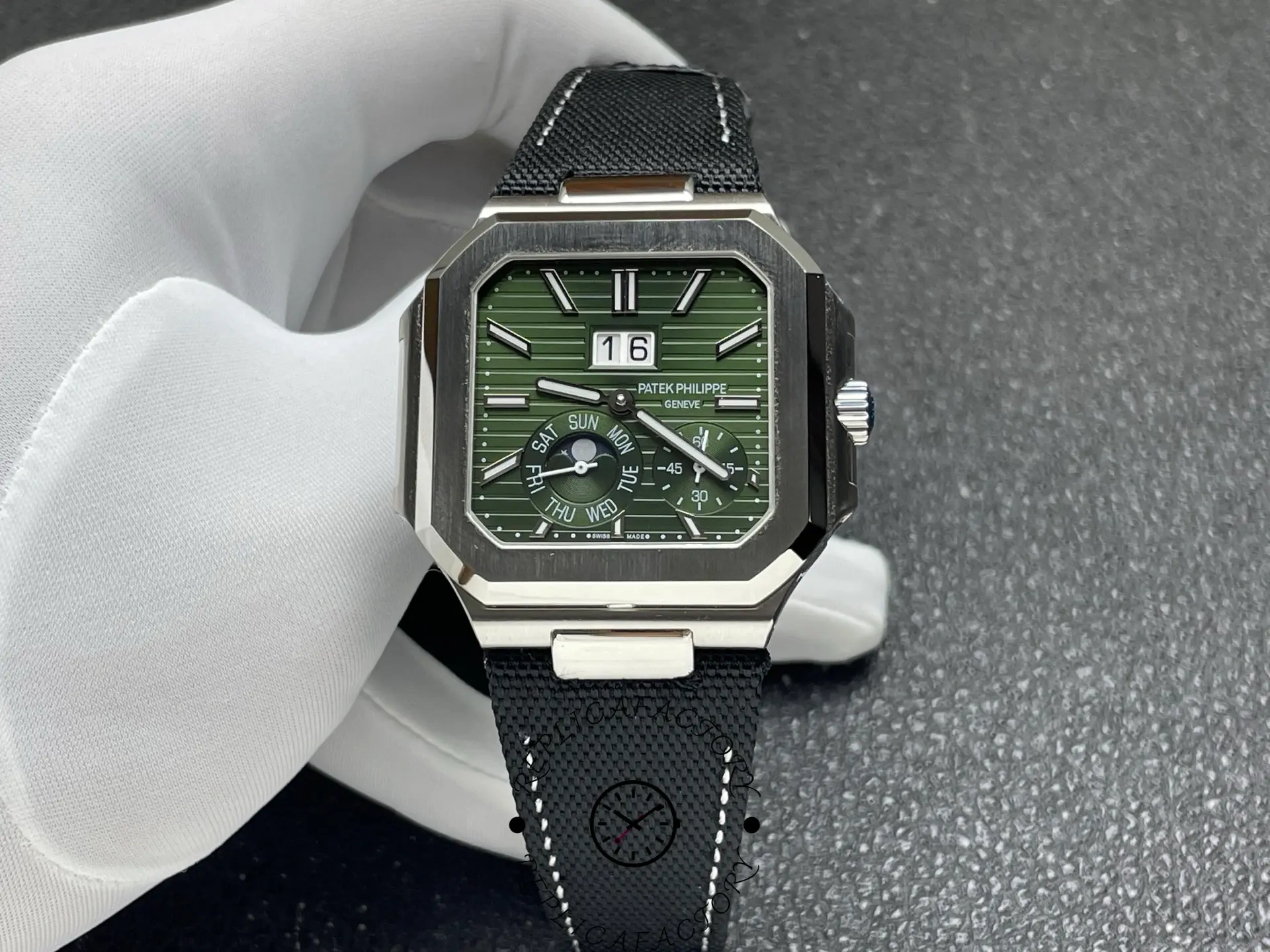 Handheld Patek Philippe 5822P displaying large date window and textured dial.