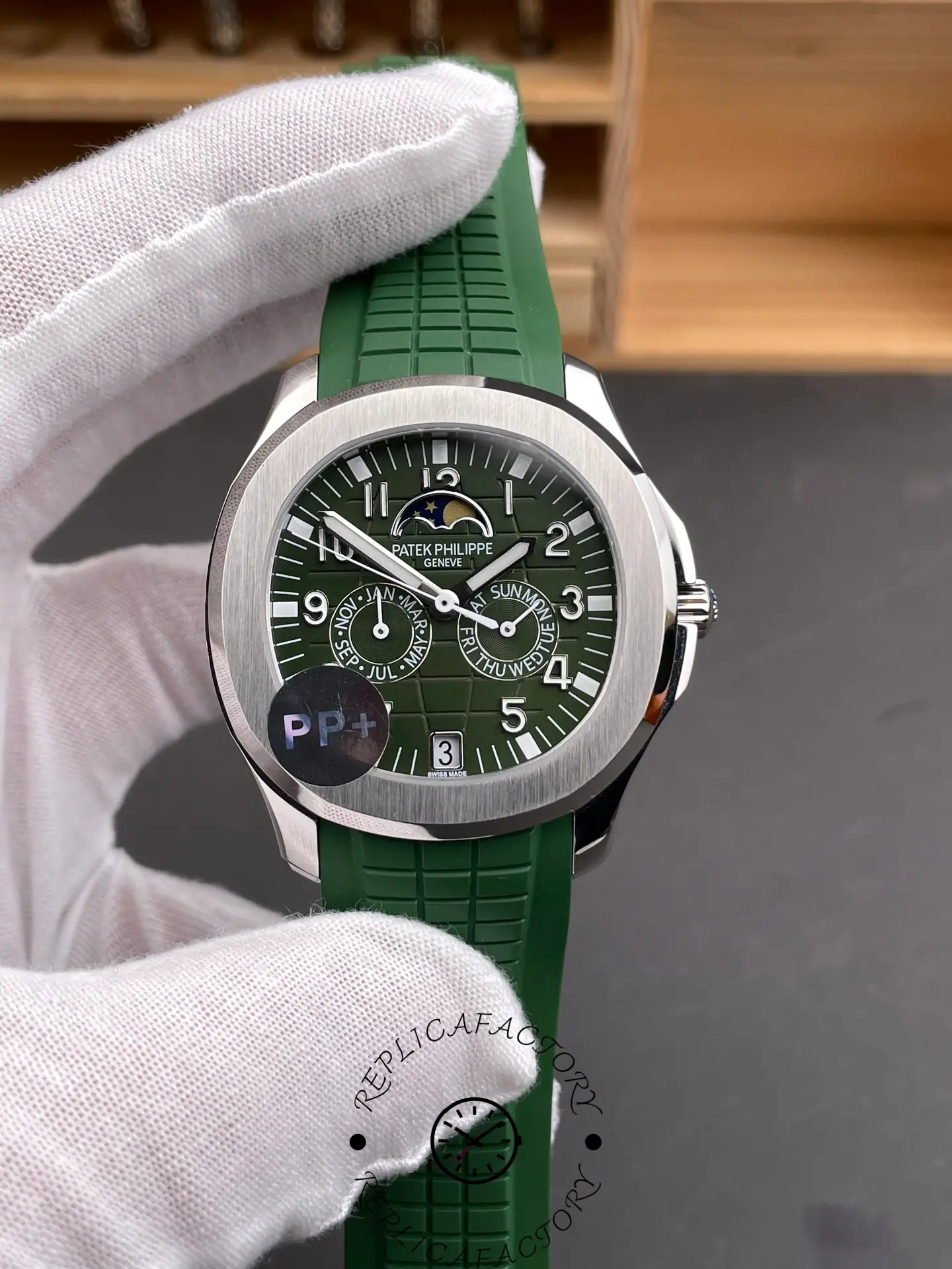 Hand-held close-up of the Patek Philippe 5261R replica with textured green strap.