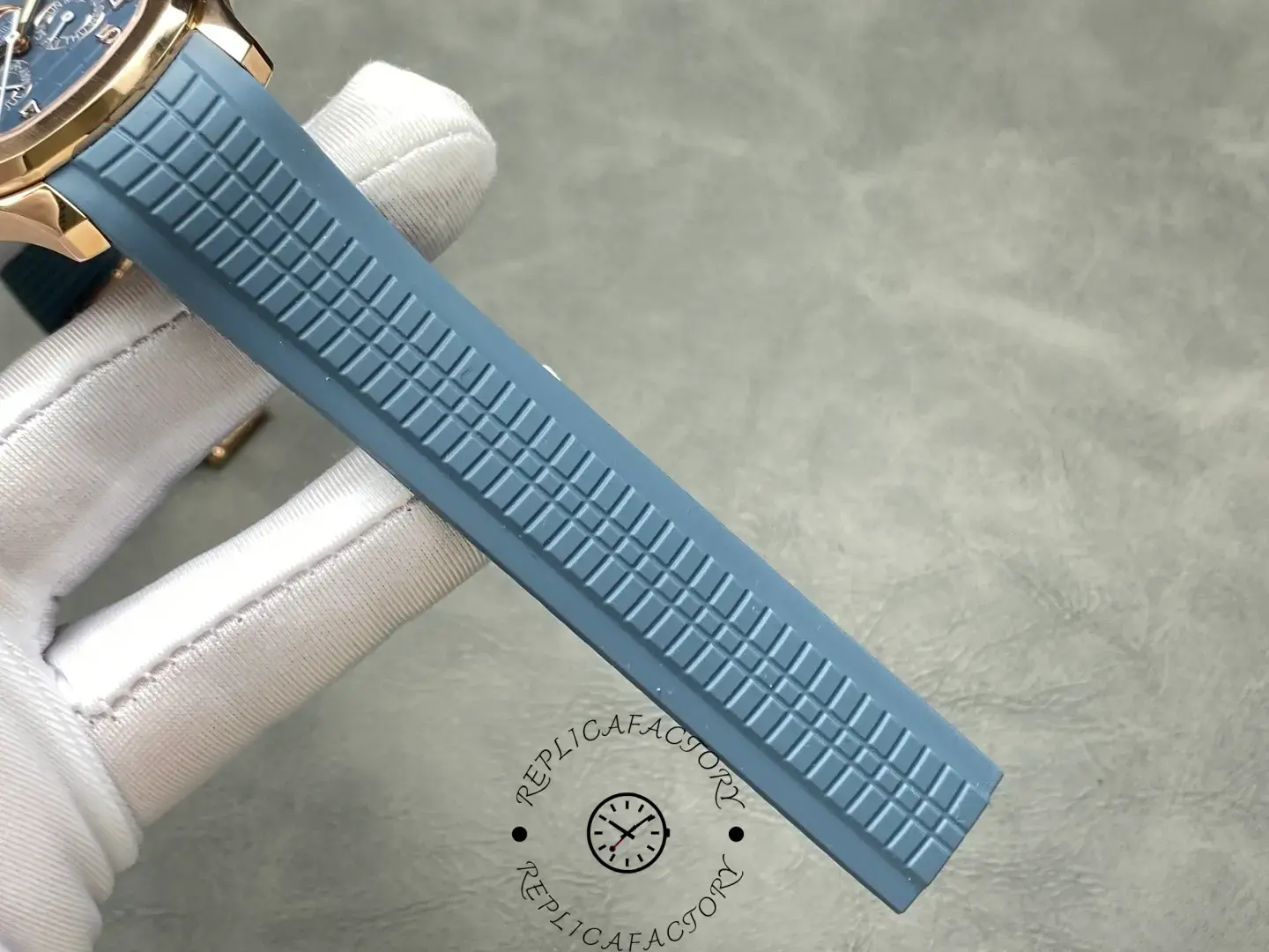 Blue rubber strap of Patek Philippe 5261R-001 replica with embossed pattern.