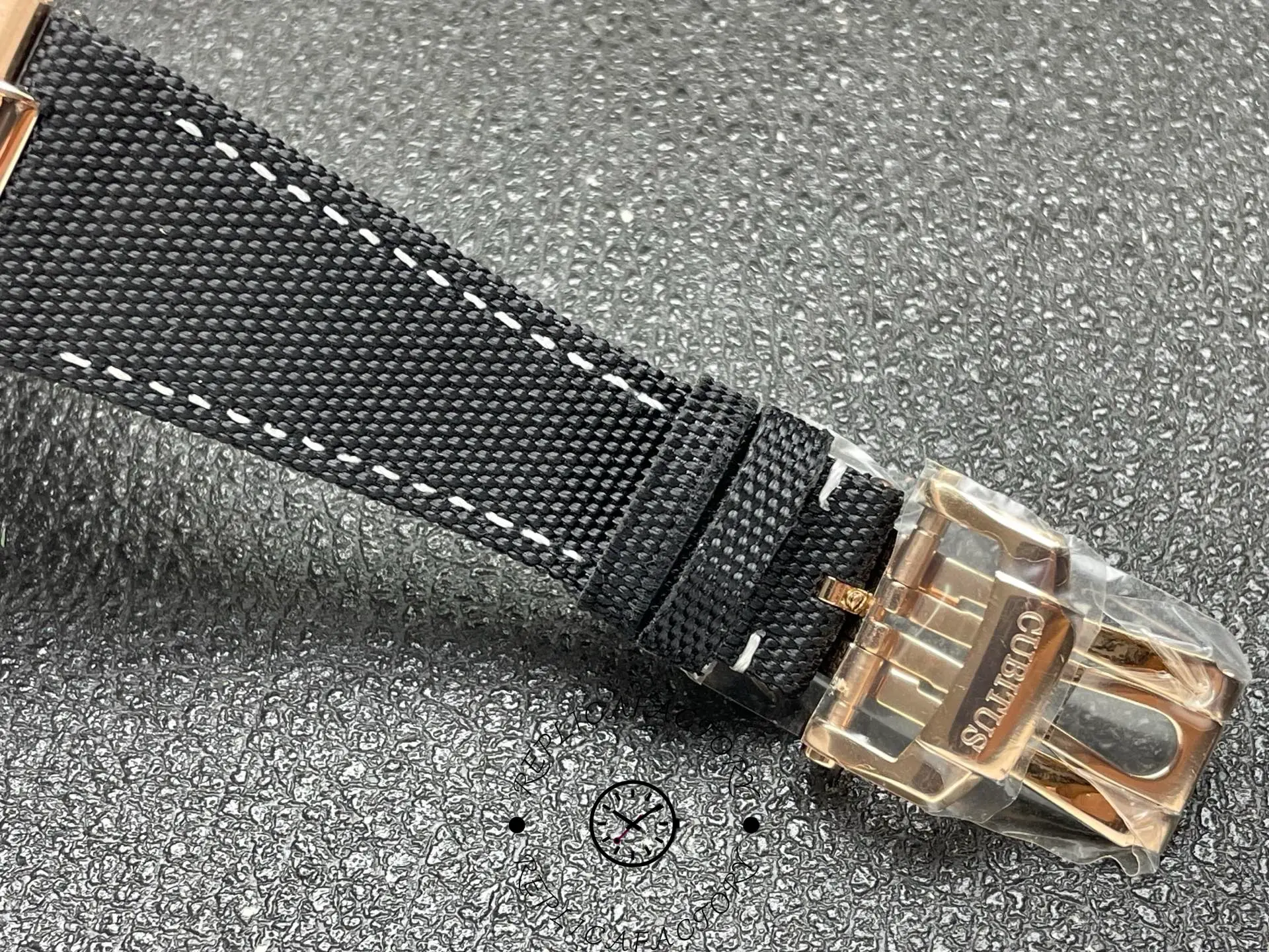 Patek Philippe 5822R replica strap and clasp close-up with rose-gold buckle.