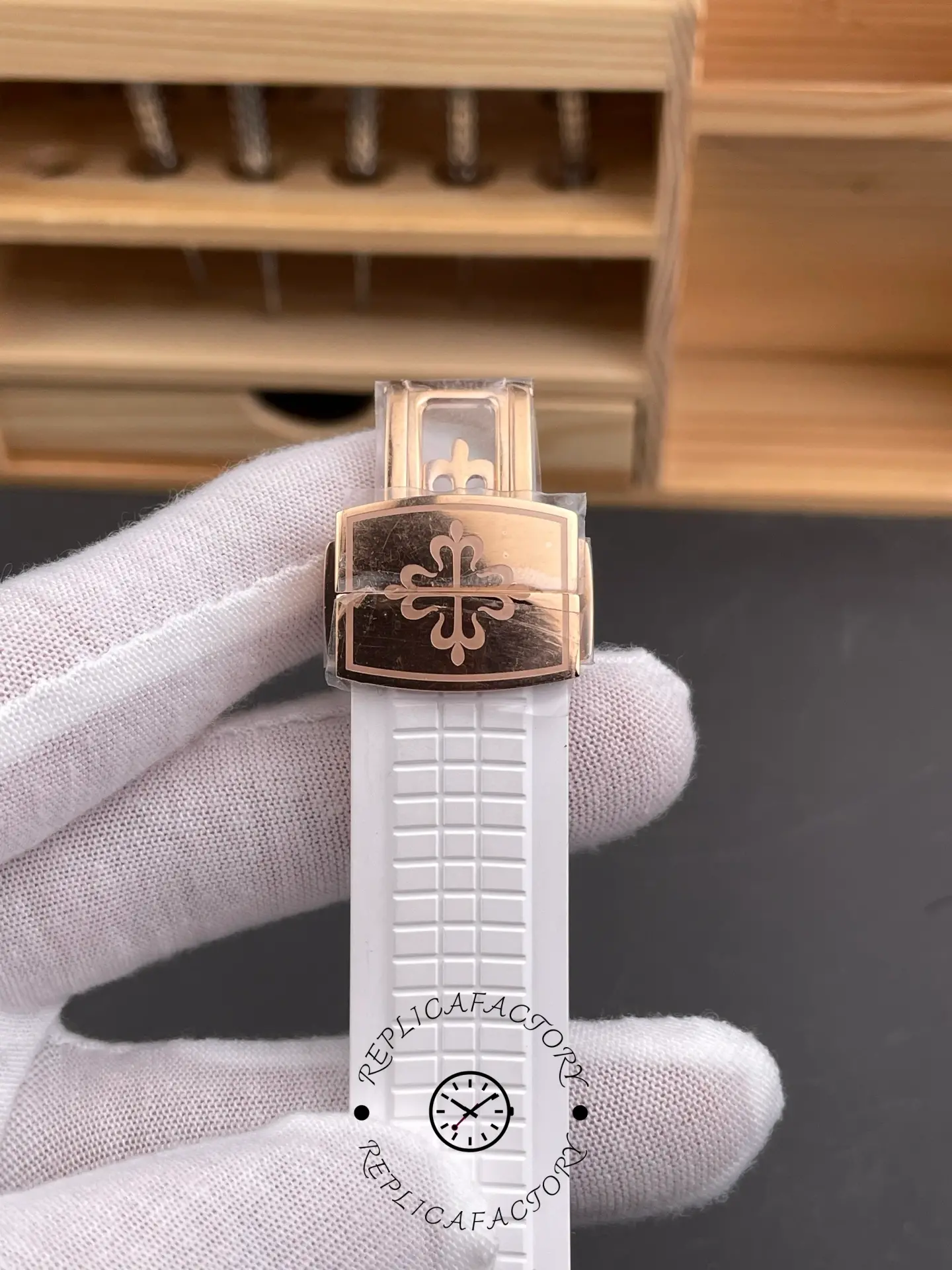Close-up of 5261R clasp with rose-gold finish and emblem engraving.