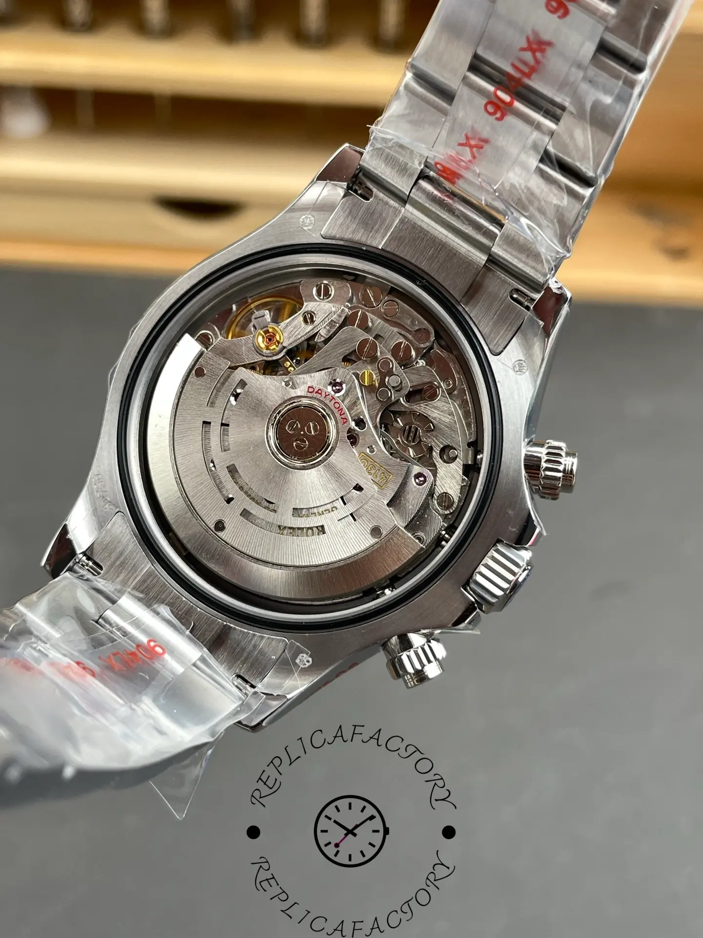 Display back view of Rolex Daytona 116509-0073 replica showing 4130 clone movement.