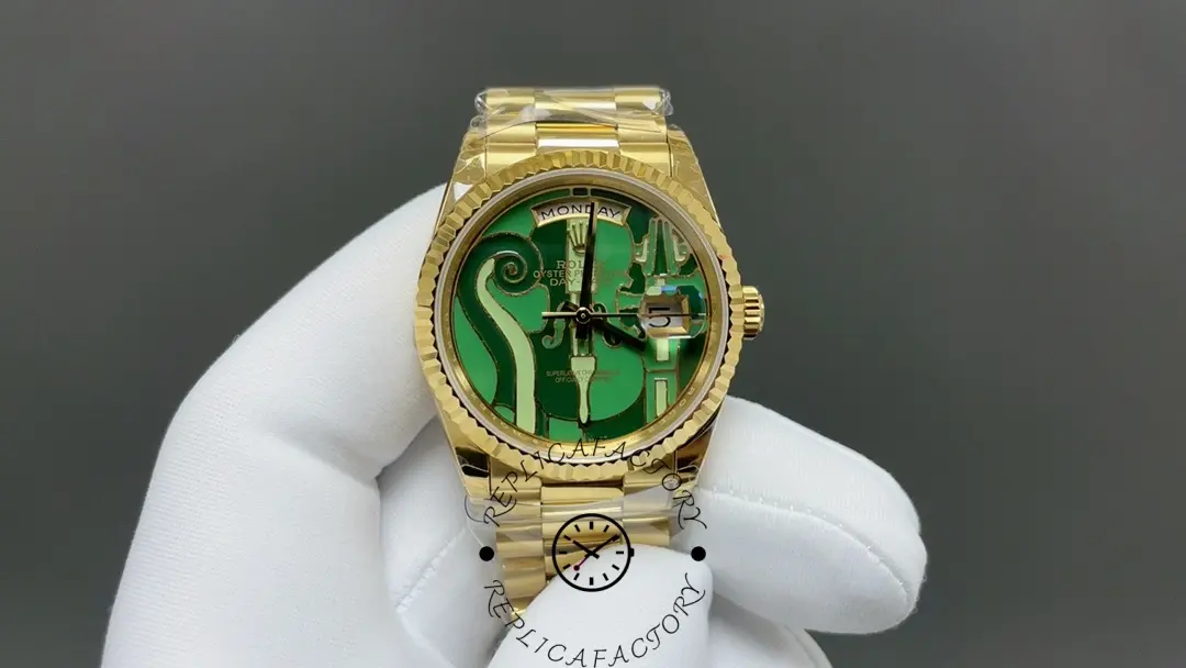 Hand-held view of Rolex 128238-VIO showing green engraved dial and fluted bezel.