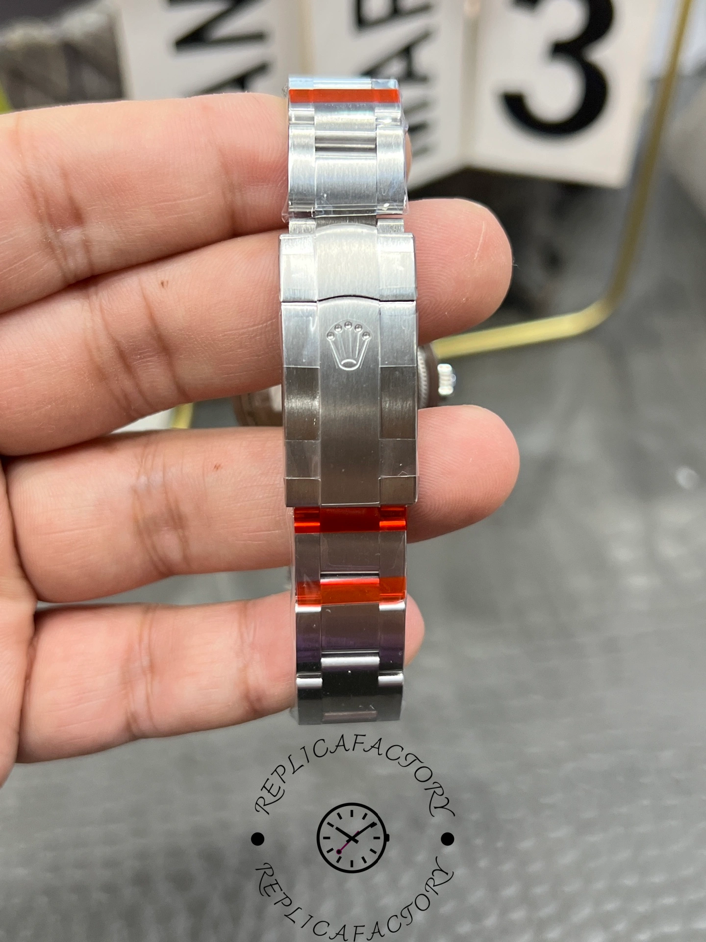 Bracelet clasp view of the Rolex Oyster Perpetual 31 277200 replica with engraved Rolex crown.