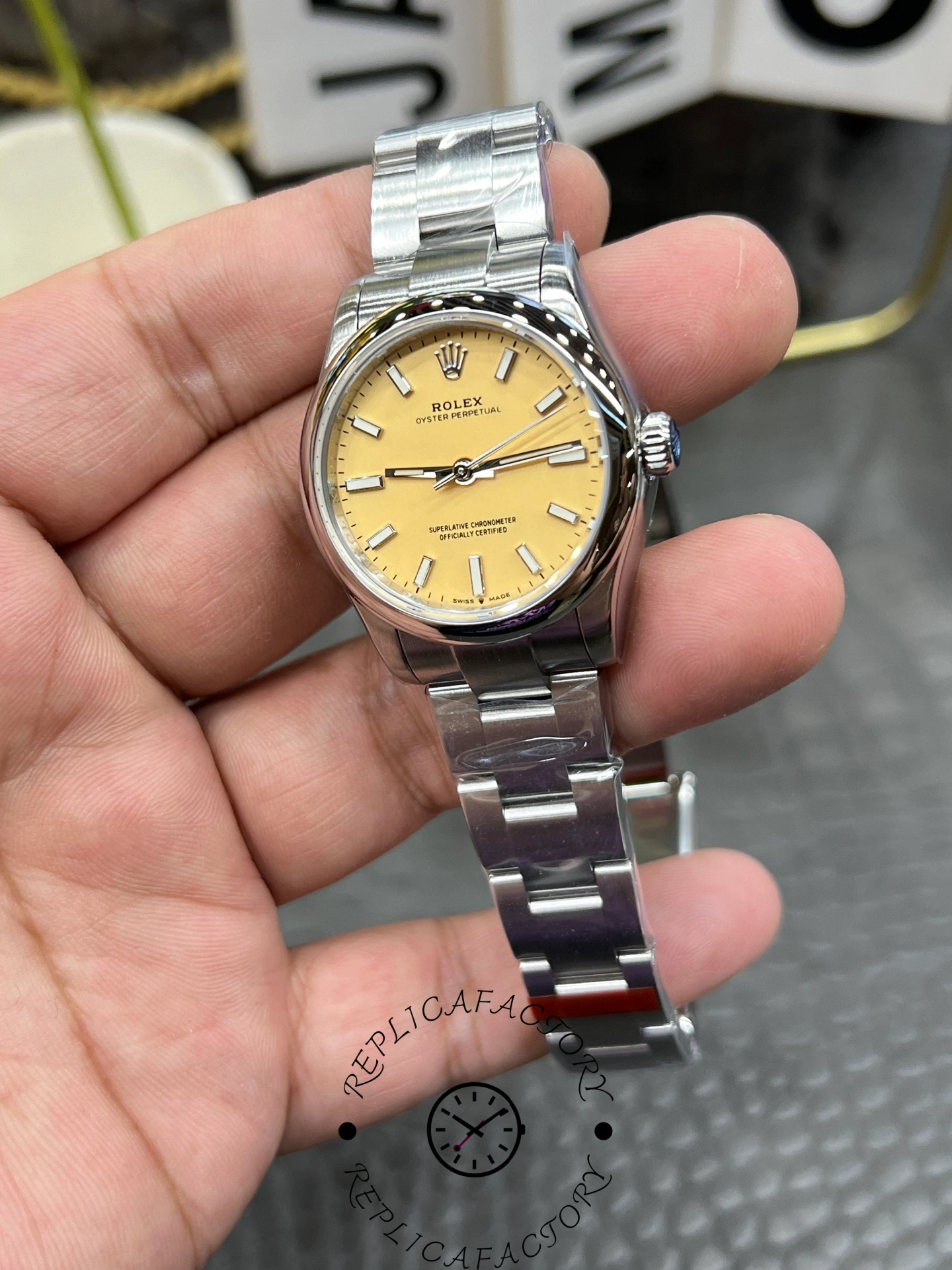 Close-up of the Rolex Oyster Perpetual 31 277200 replica dial with applied baton hour markers and central seconds hand.