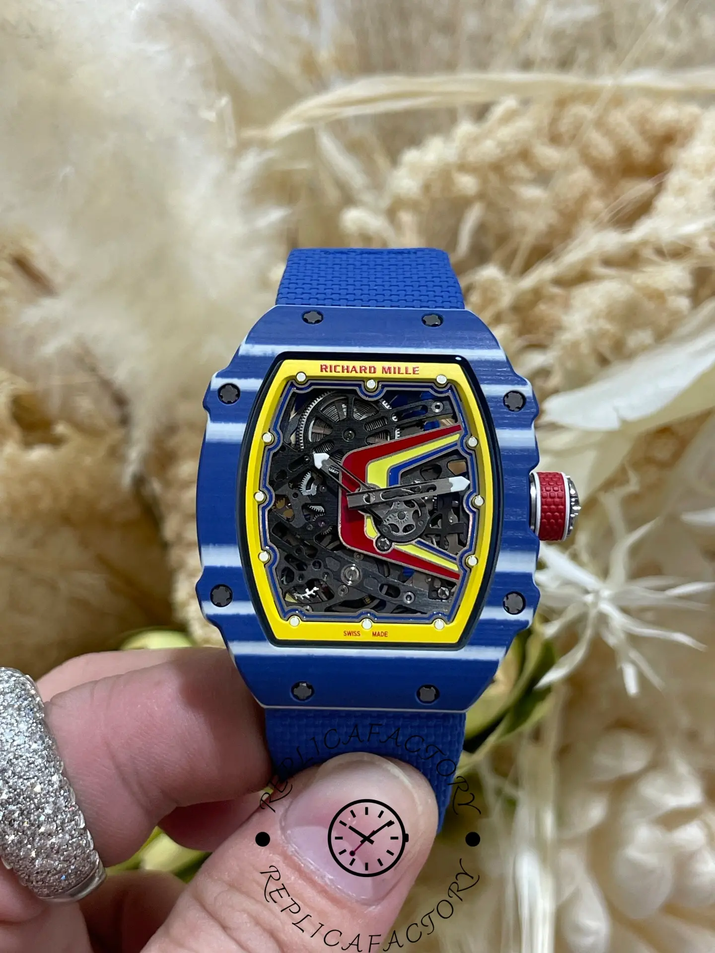 Hand-held front view of Richard Mille RM 67-02 replica highlighting carbon-style case and skeleton movement.