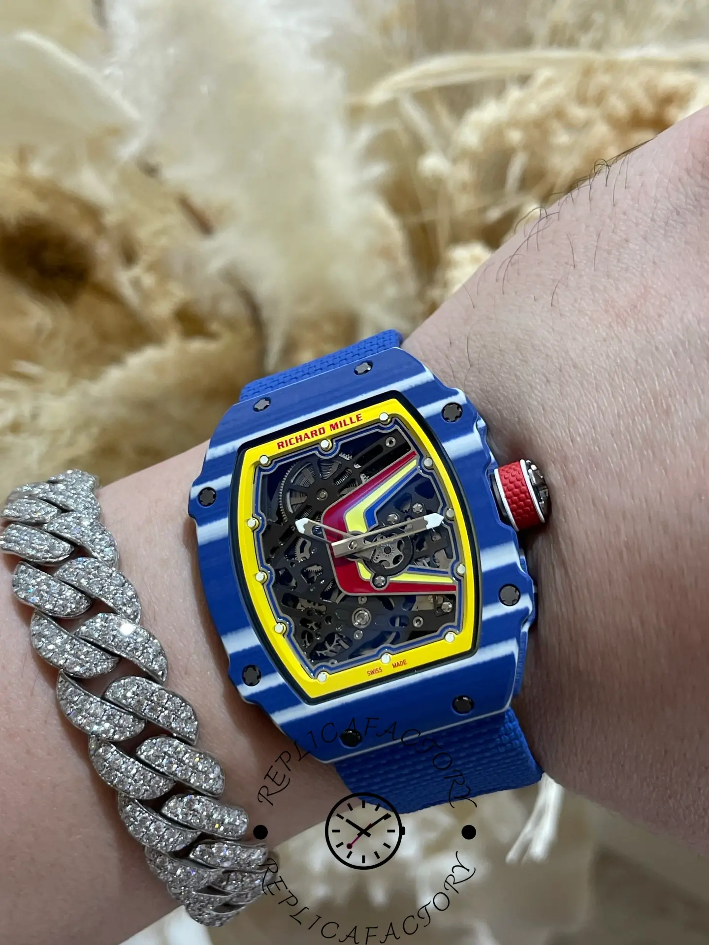 Angled wrist view of Super Clone Richard Mille RM 67-02 Fernando Alonso Azul highlighting blue case and red crown.