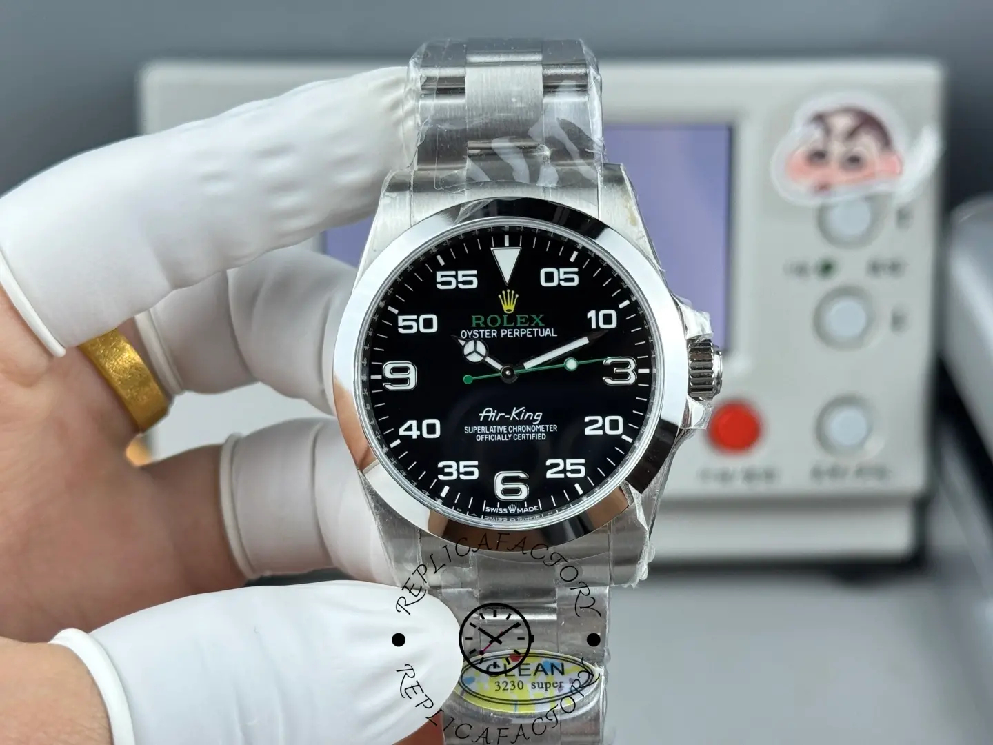 Front view of Rolex Air-King 126900 showing black dial, 3-6-9 numerals, green seconds hand and smooth bezel.