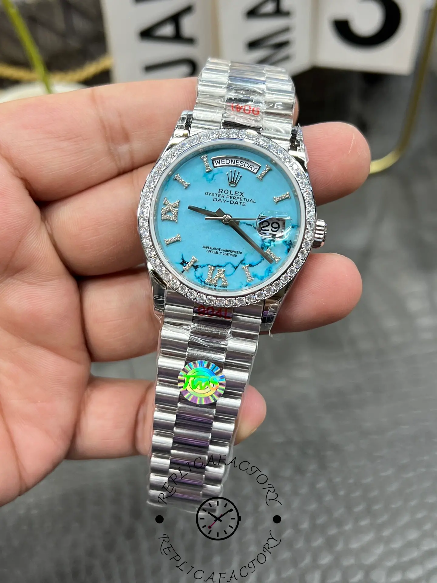 Close-up of Rolex Day-Date 128349RBR-0031 turquoise dial with day window at 12 o’clock.