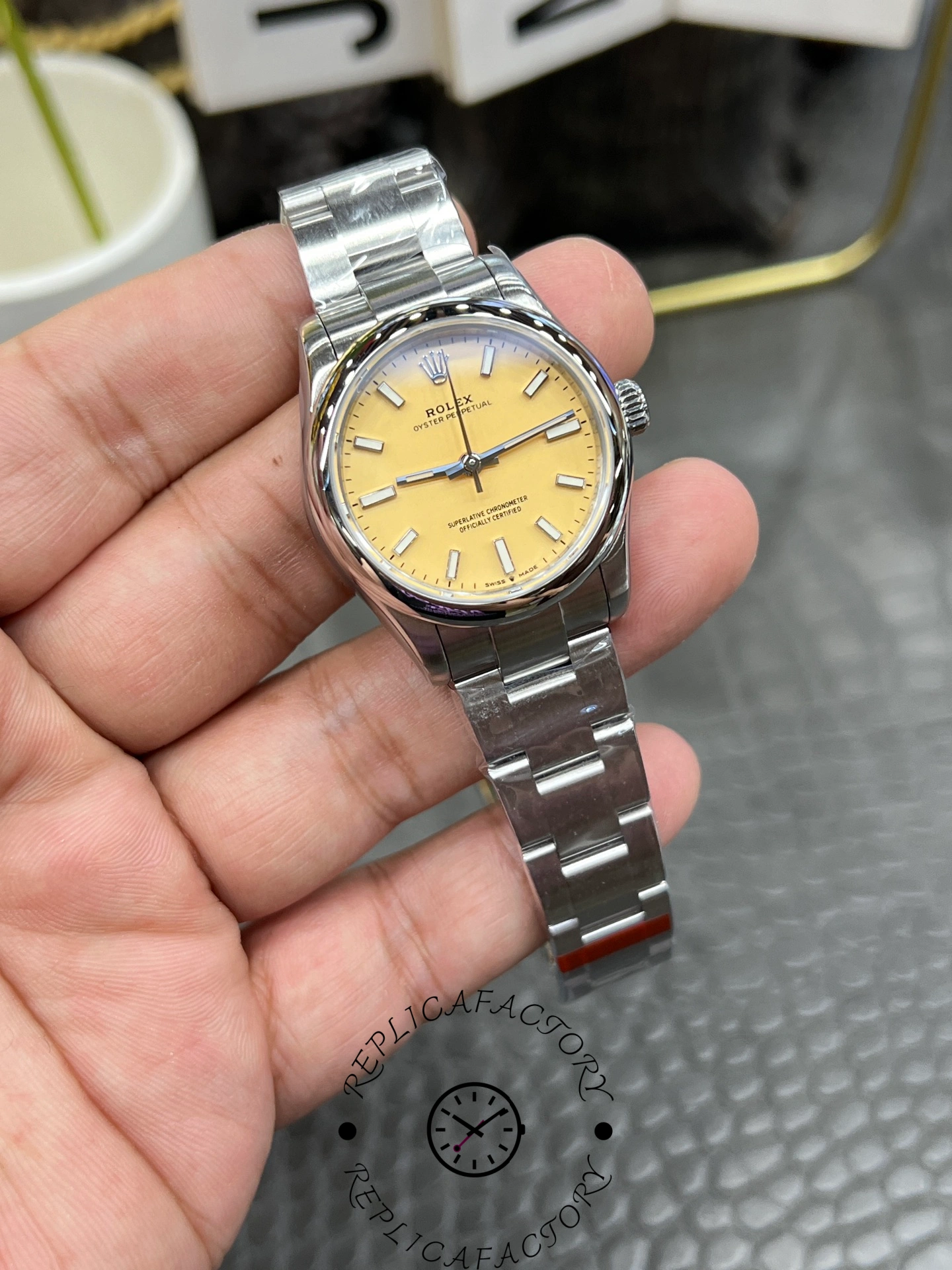 Angled front view of the Rolex Oyster Perpetual 31 277200 replica highlighting polished case and smooth bezel design.