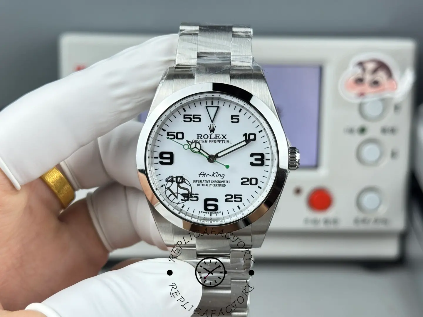 Hand-held view of Rolex Air-King 126900 highlighting the white dial and green seconds hand.