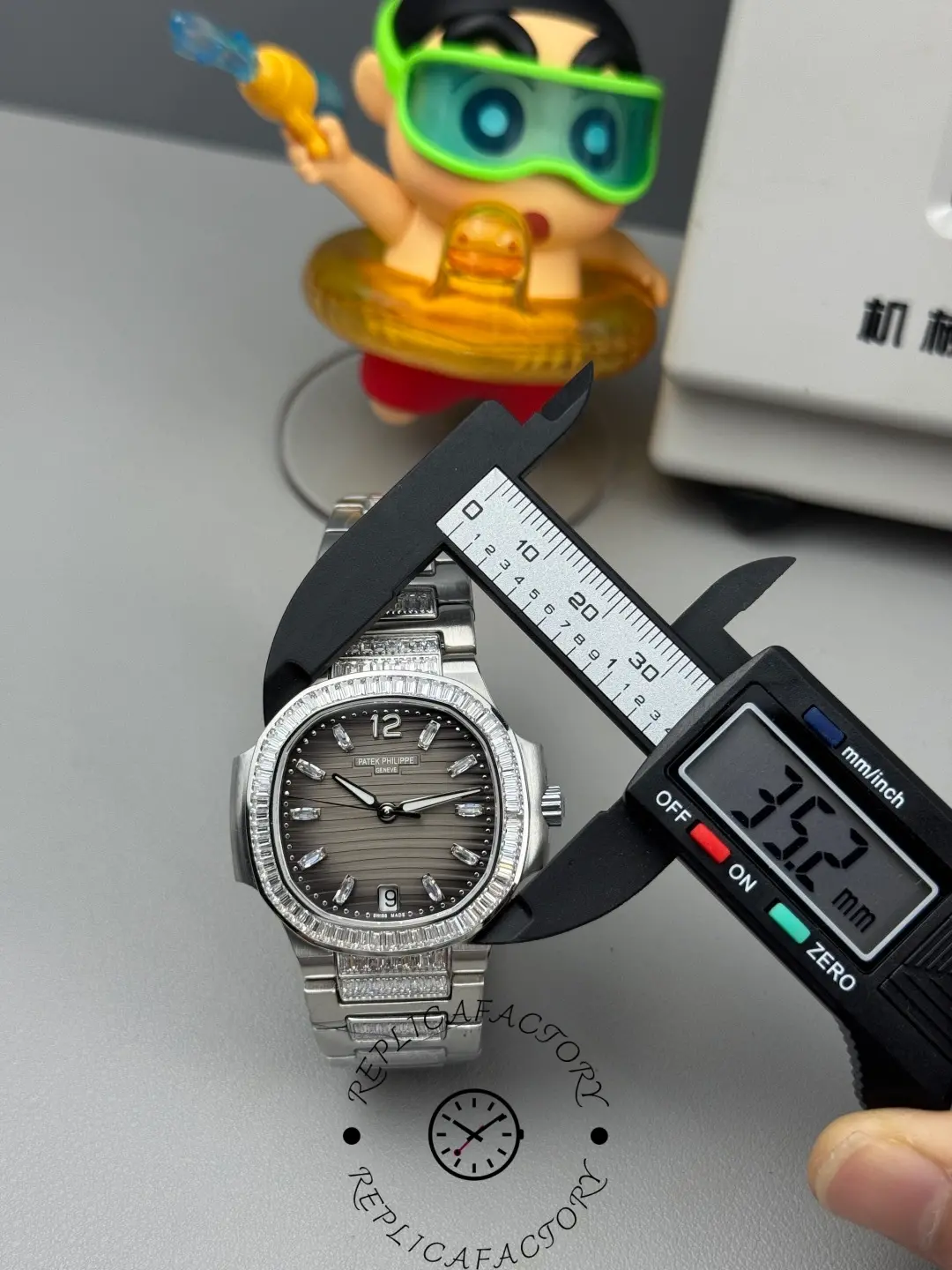 Measurement view of Nautilus 7014-1G-001 replica showing case diameter being measured with digital caliper.