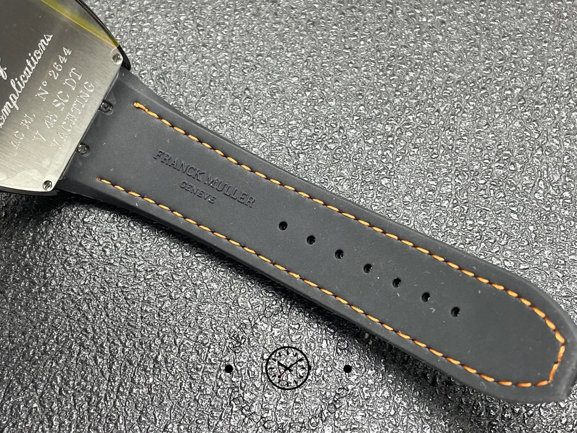 Strap detail of Franck Muller V 45 SC DT YACHT CR NR showing orange stitching.