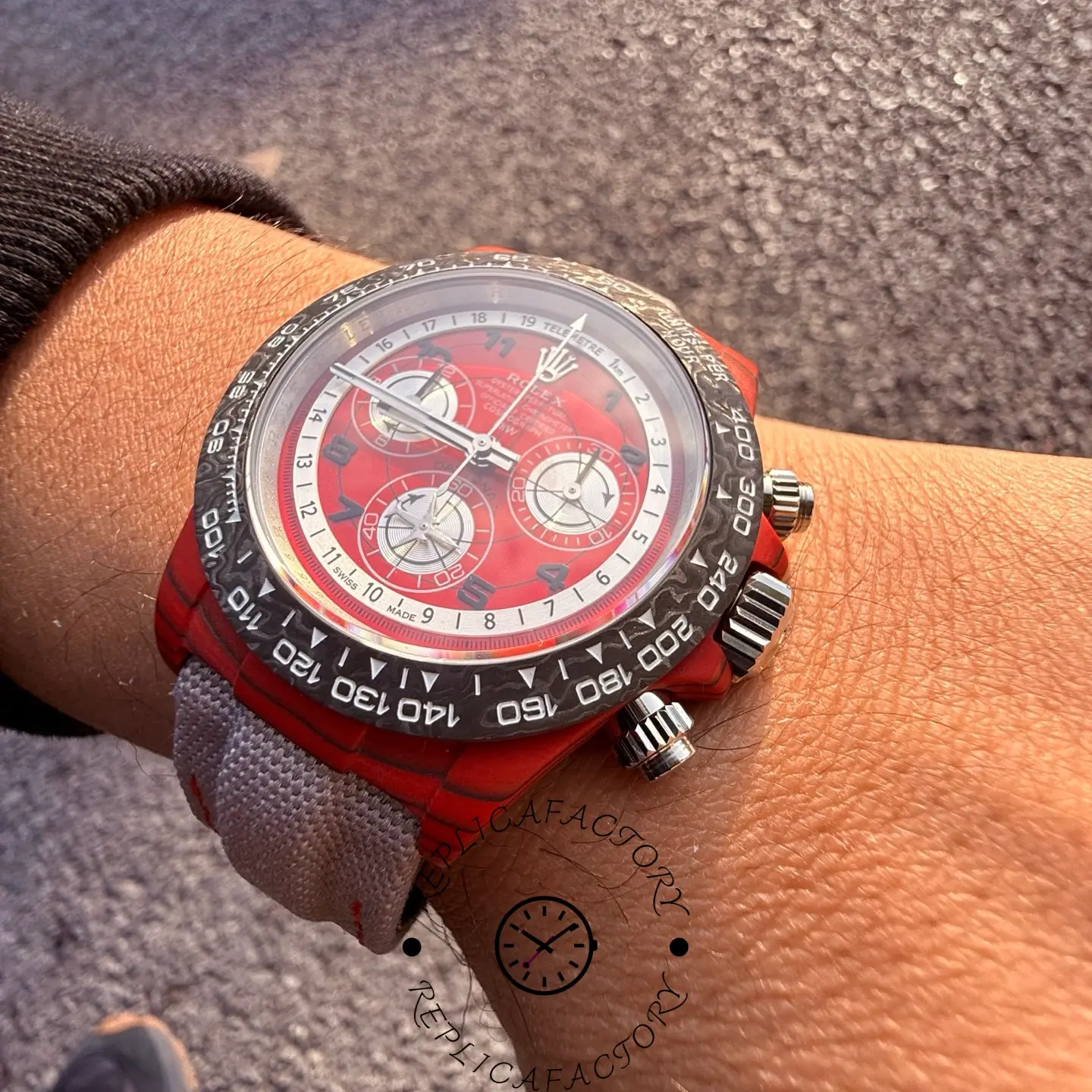 Side wrist view of the Rolex Daytona DiW highlighting carbon bezel texture and screw-down pushers.